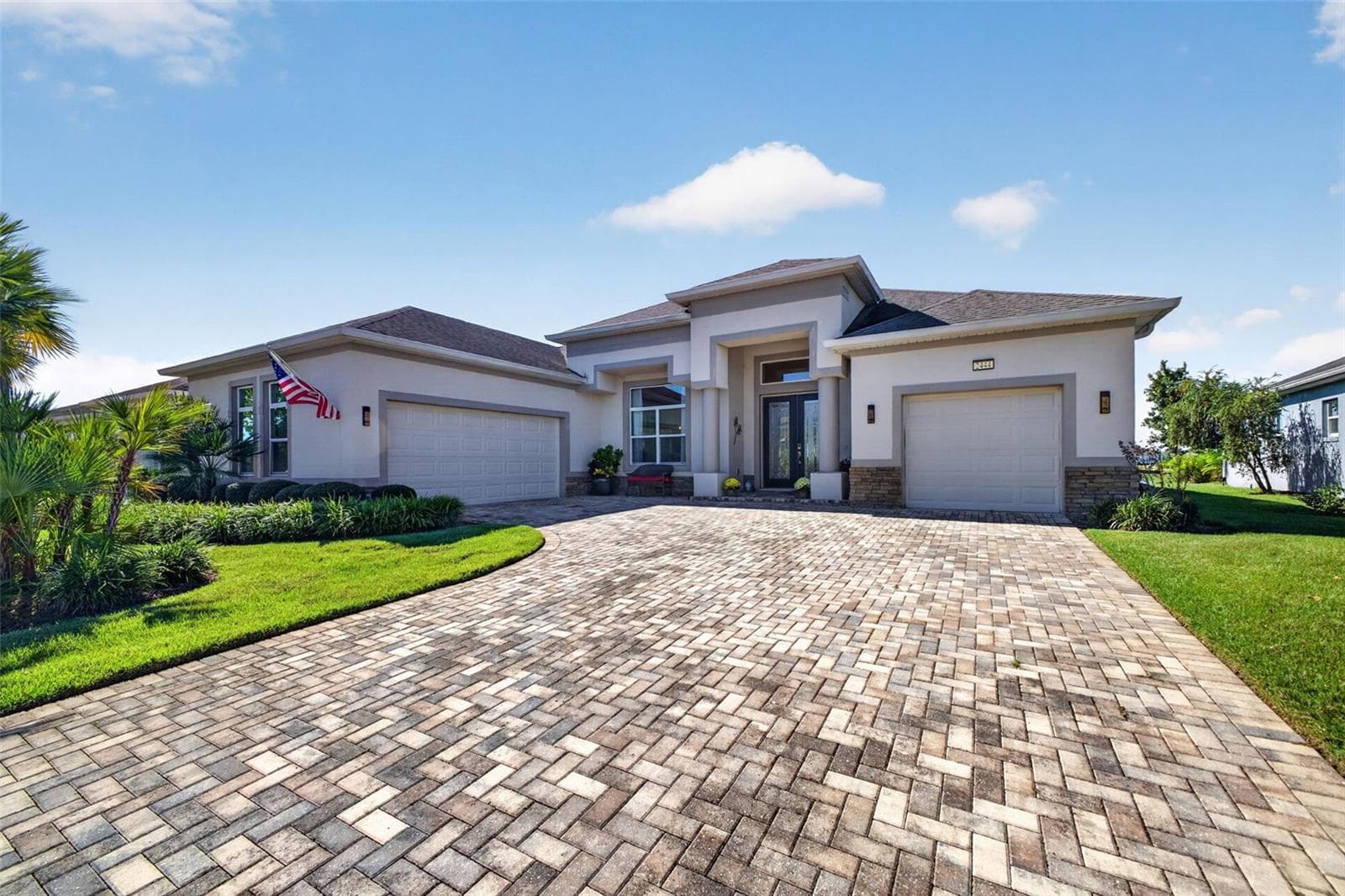 An expansive paver driveway offers ample parking and sets a warm, elegant tone the moment you arrive. - 2444 PAWTUCKET PASS, MOUNT DORA