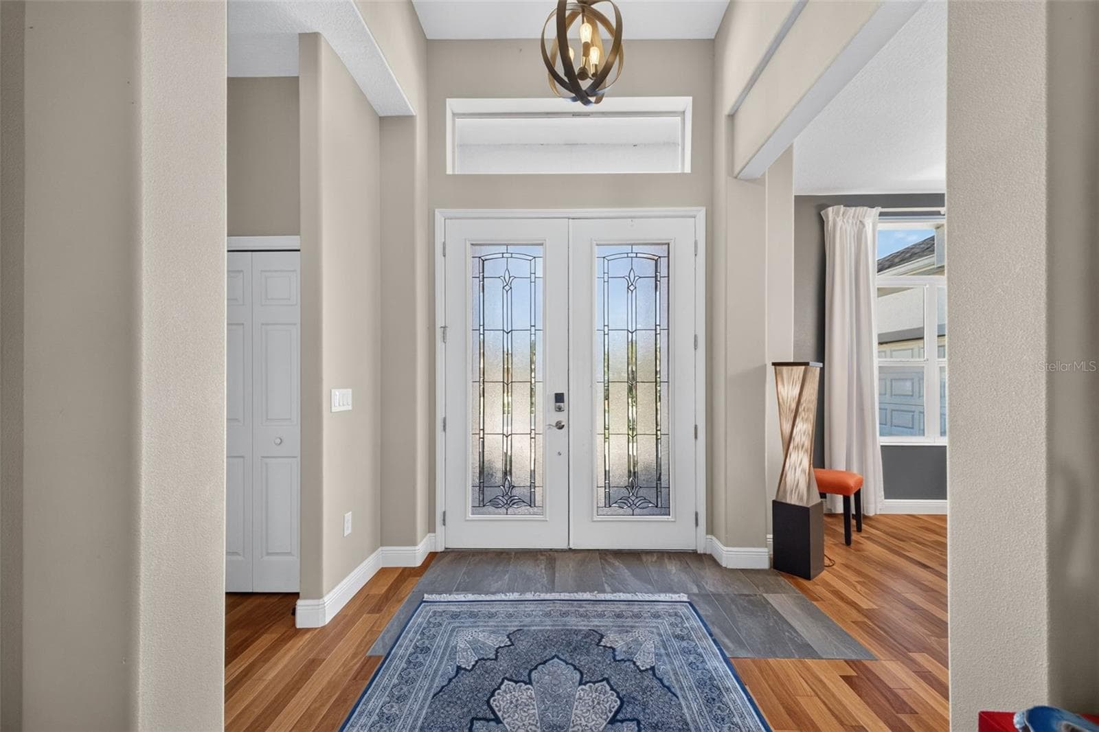 Make a memorable entrance in a dramatic, sun-filled foyer highlighted by soaring ceilings and architectural elegance. - 2444 PAWTUCKET PASS, MOUNT DORA