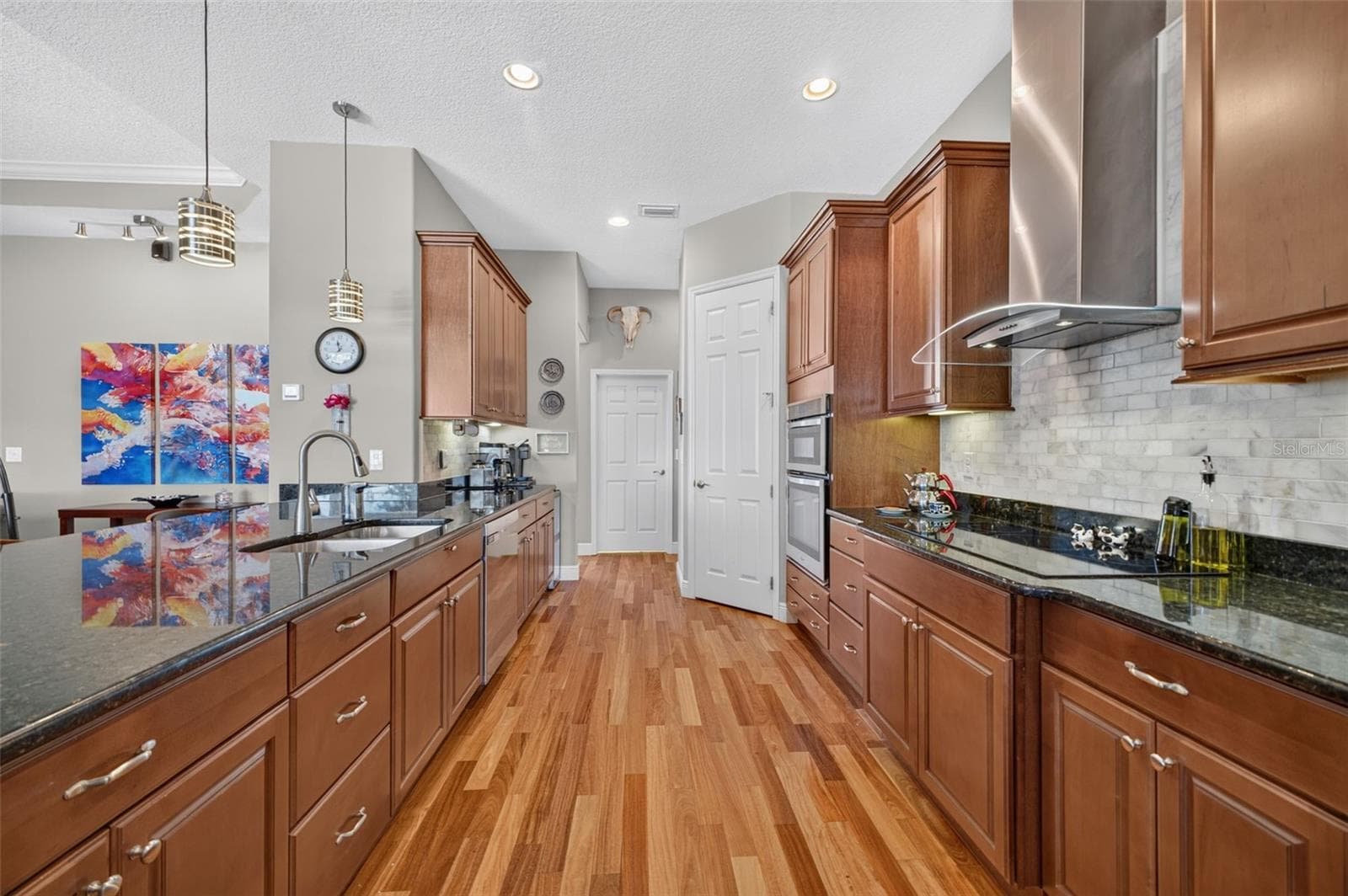 The beautifully appointed kitchen opens conveniently to a walk-in pantry and a dedicated indoor laundry room. - 2444 PAWTUCKET PASS, MOUNT DORA