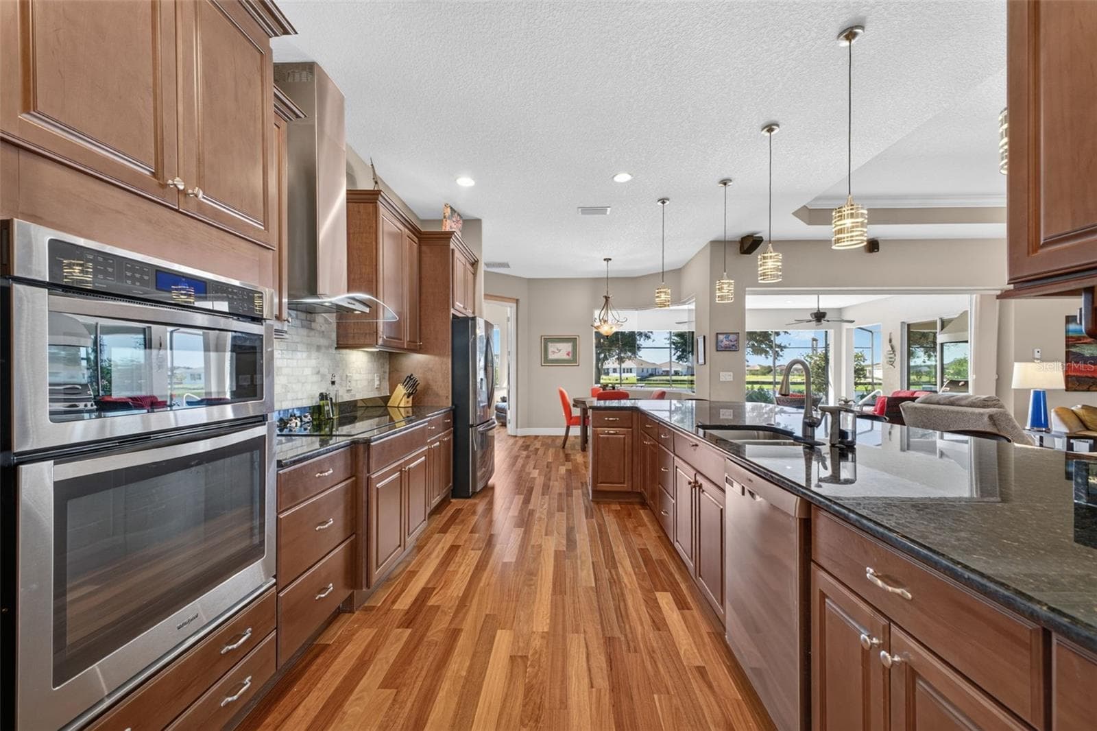 Double-oven configuration, featuring a built-in microwave/convection oven combination set above a traditional wall oven. - 2444 PAWTUCKET PASS, MOUNT DORA