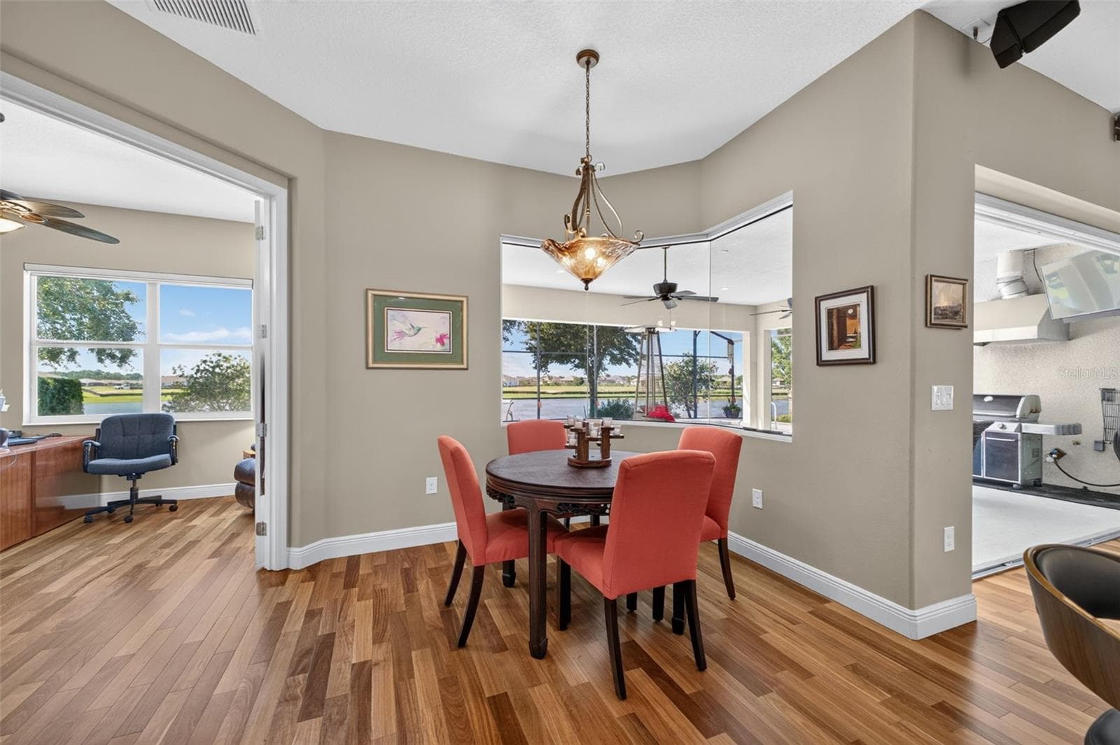 Conveniently situated just off the breakfast room, the private home office boasts tranquil lake views for an inspiring workspace. - 2444 PAWTUCKET PASS, MOUNT DORA