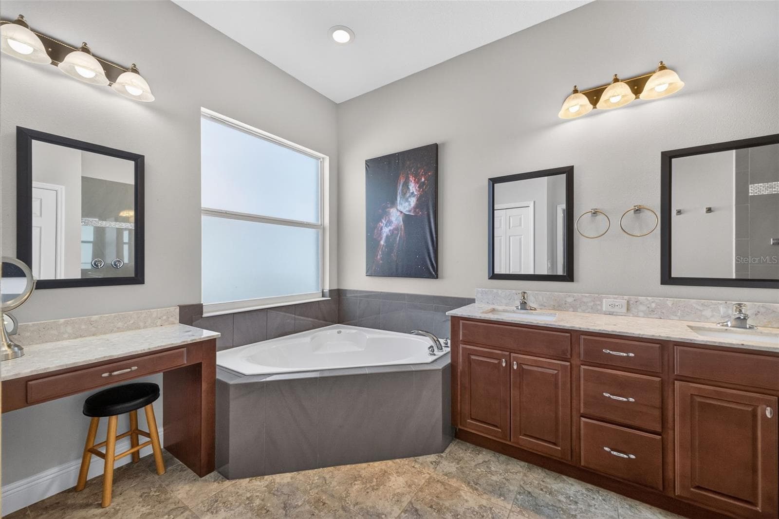 The spa-inspired en-suite bath features an oversized garden tub, offering a tranquil retreat for evening relaxation. - 2444 PAWTUCKET PASS, MOUNT DORA