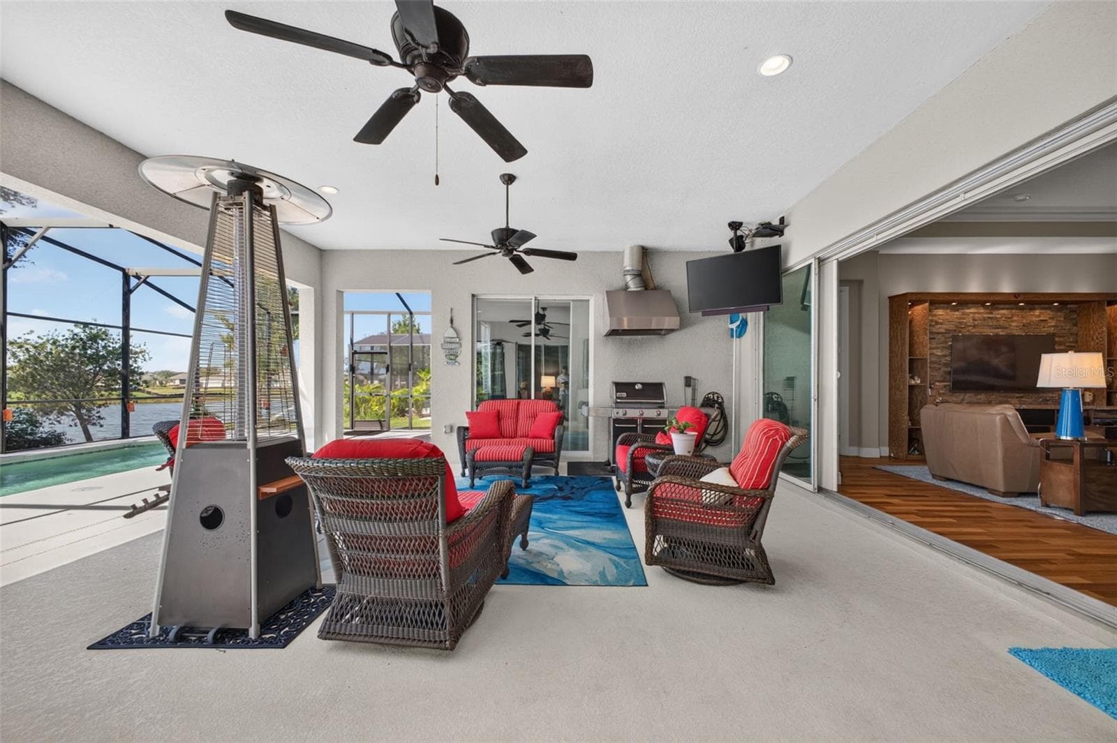 Experience quintessential indoor-outdoor living as pocket glass sliders open wide to merge the interior living space effortlessly with the covered lanai. - 2444 PAWTUCKET PASS, MOUNT DORA