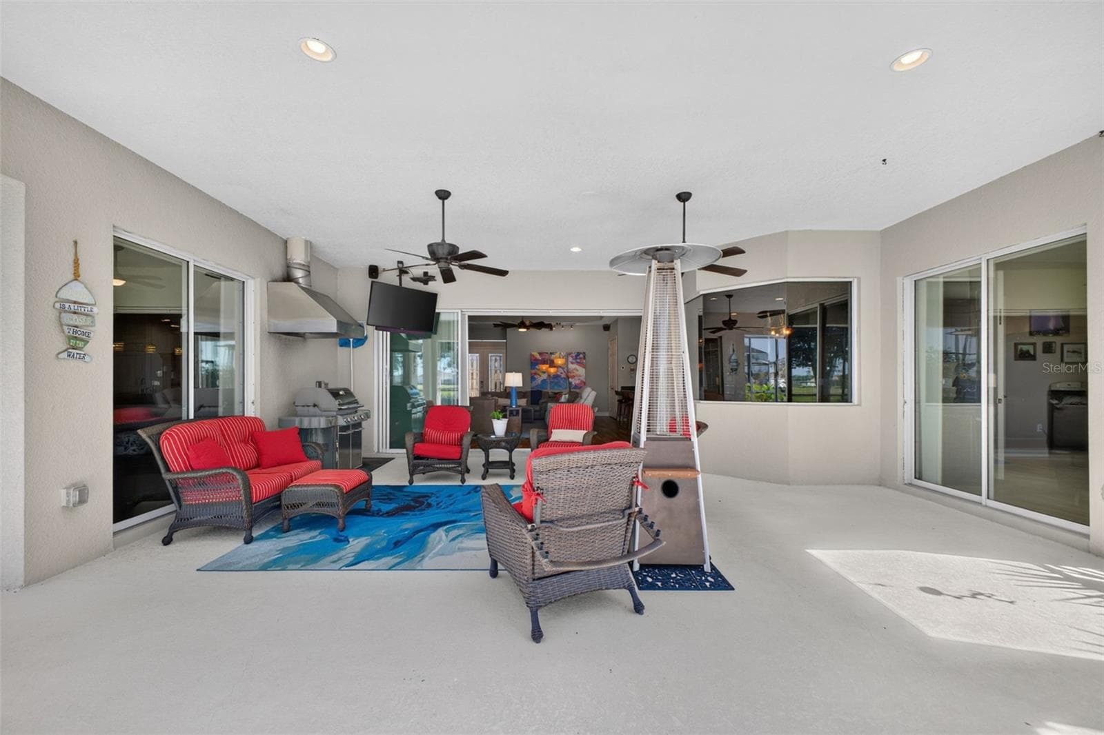 Designed for resort-style relaxation, the spacious covered lanai provides a seamless outdoor living area perfect for post-pool lounging and entertaining. - 2444 PAWTUCKET PASS, MOUNT DORA