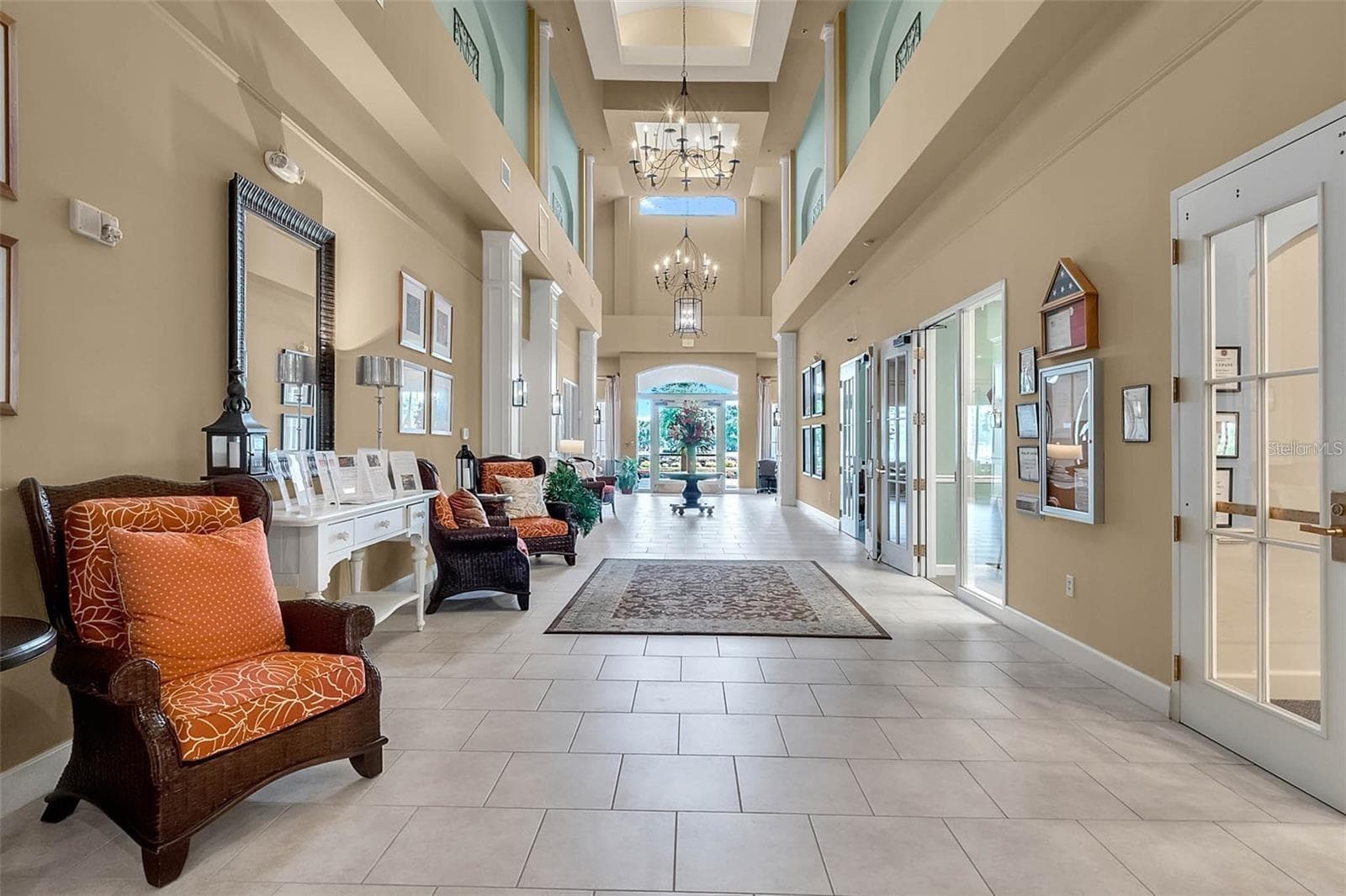The clubhouse grand hallway features soaring ceilings and elegant architectural details, welcoming residents to the heart of the community. - 2444 PAWTUCKET PASS, MOUNT DORA