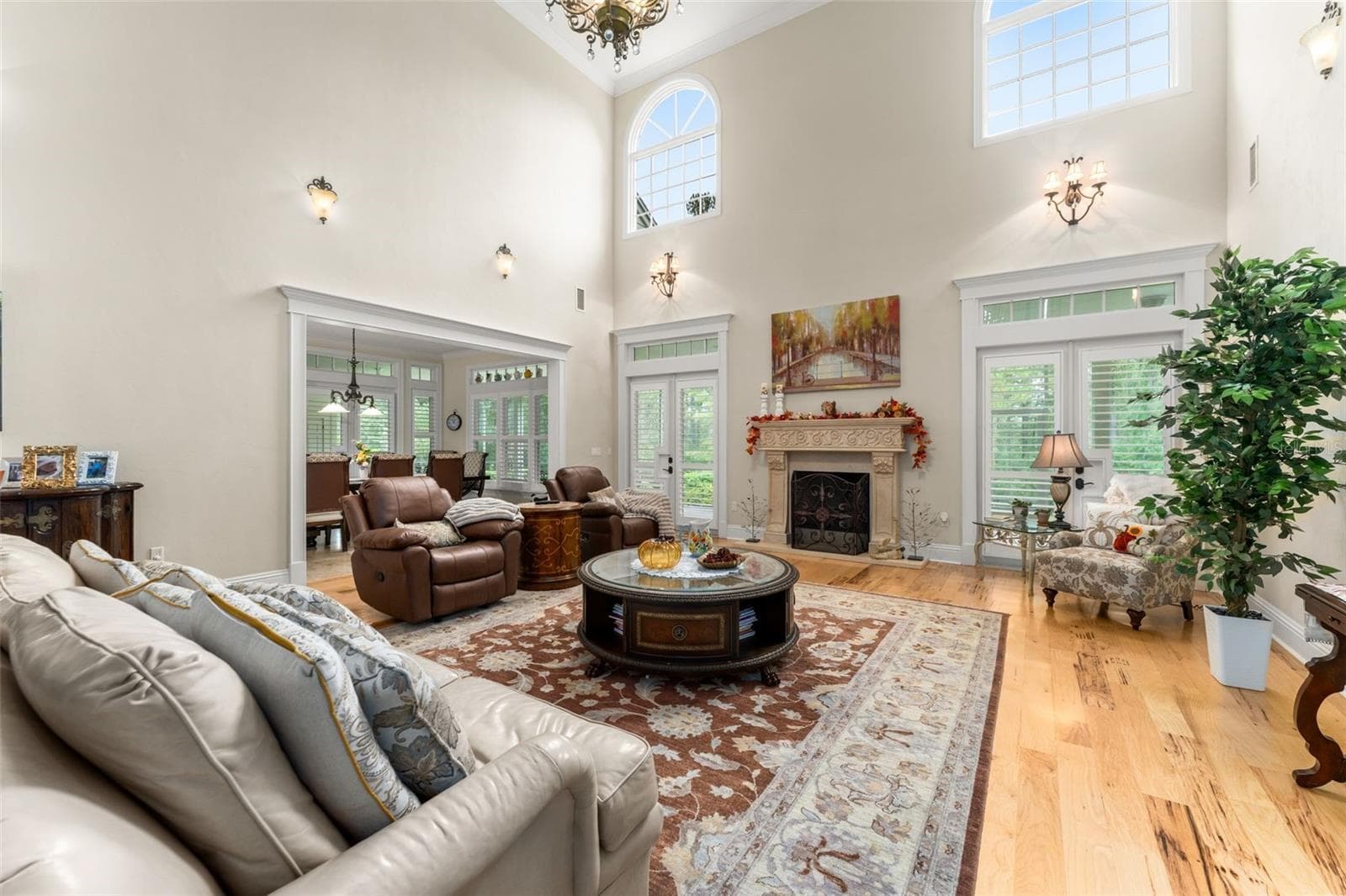 Family room with 22' ceiling and large windows to bring in natural sunlight - 9691 NW 53RD DR, GAINESVILLE