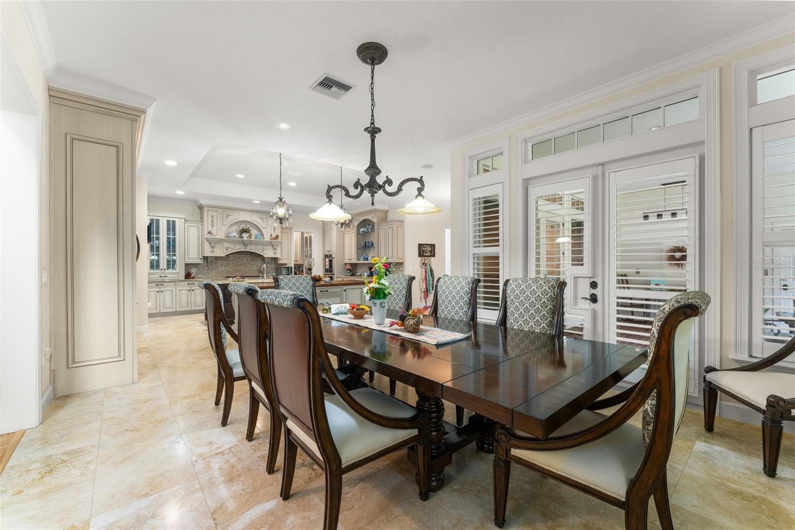 full size dining table in Kitchen area with doors leading out to screened in porch - 9691 NW 53RD DR, GAINESVILLE