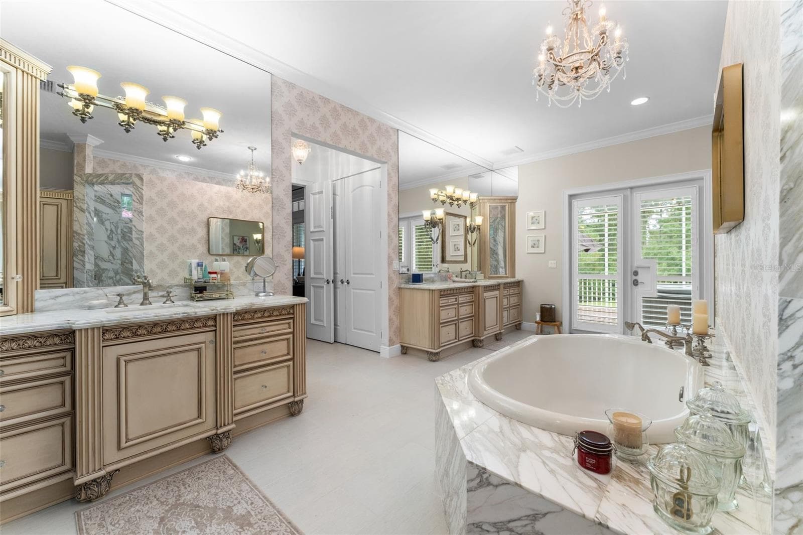 Master bath with dual vanities and door leading to private screened porch - 9691 NW 53RD DR, GAINESVILLE