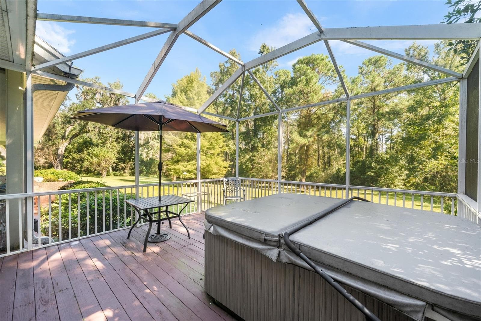 Screened porch with hot tub off of master bathroom - 9691 NW 53RD DR, GAINESVILLE