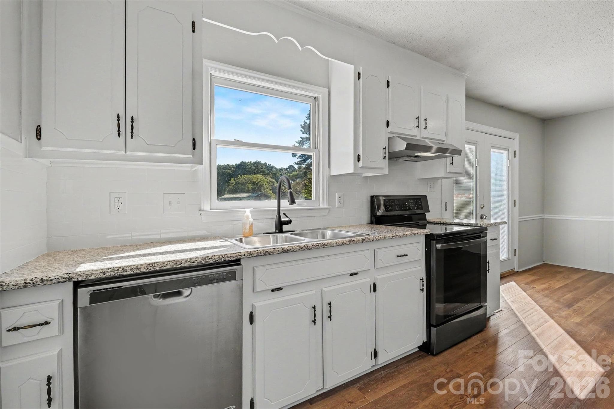 Your updated kitchen featuring granite and stainless steel appliances. - 102 Roxie Lane, Belmont