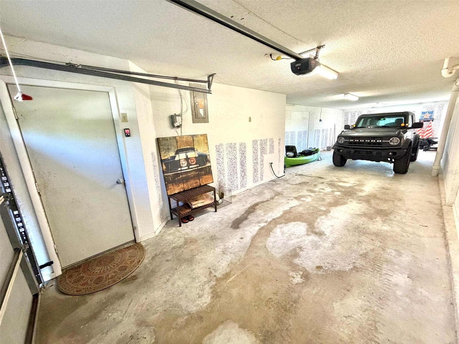 Tandem THREE CAR Garage with access to the private patio and additional storage space. - 19201 VISTA LN #D2, INDIAN SHORES