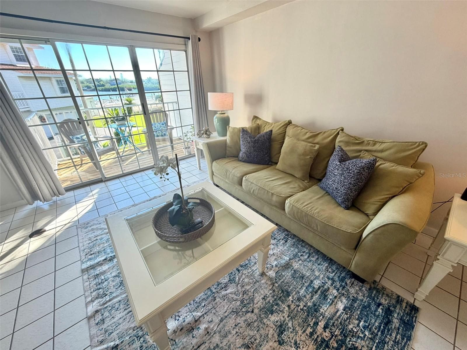 Living Room on Main Living Level with Private Deck with Intracoastal and Pool views. - 19201 VISTA LN #D2, INDIAN SHORES