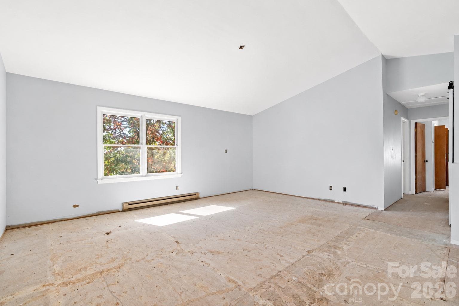 Light-filled living space with vaulted ceilings and plenty of room to make it your own. - 117 Spivey Mountain Road, Asheville