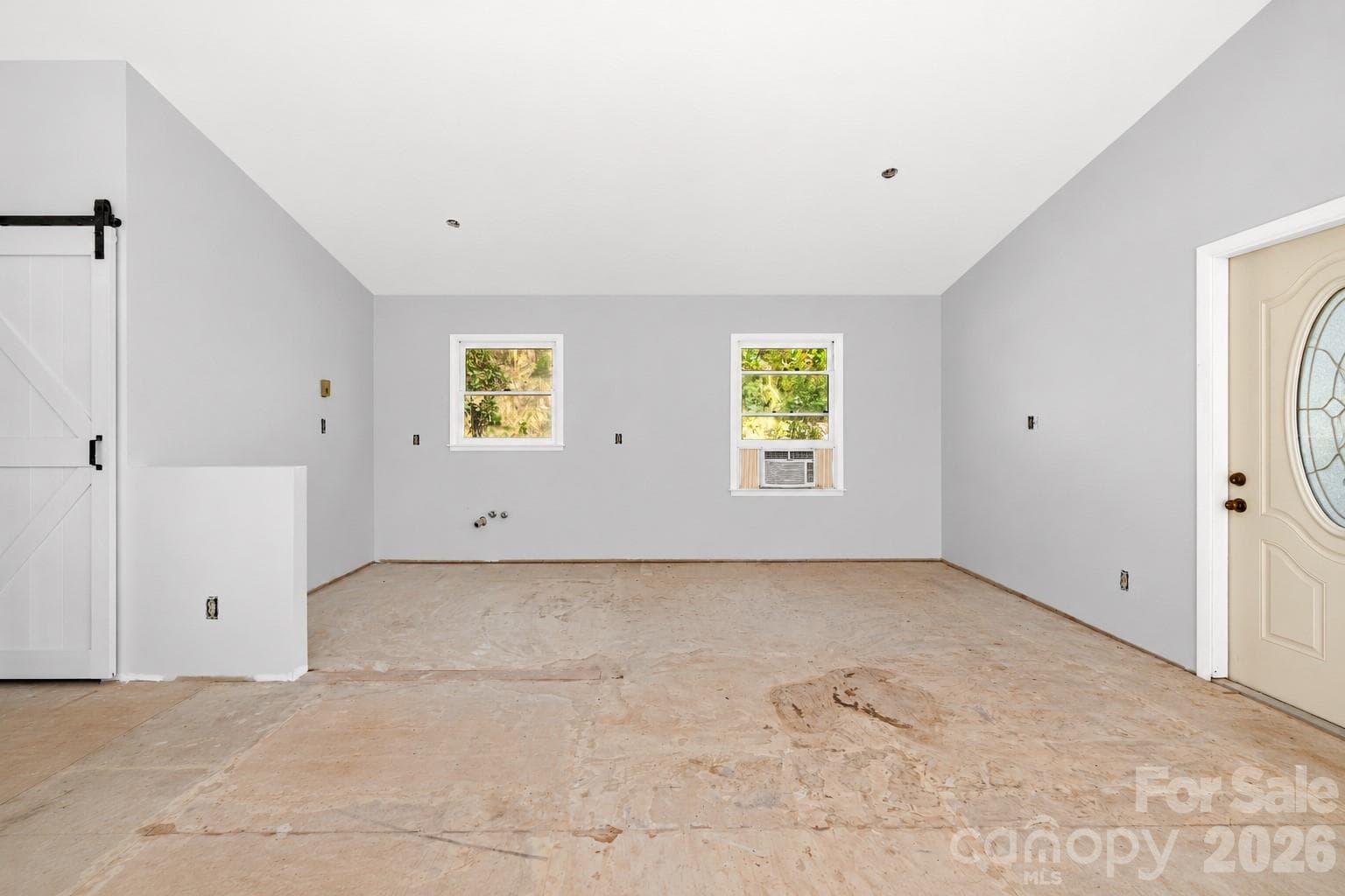 Open-concept living and kitchen space creates a bright, comfortable flow for everyday living. - 117 Spivey Mountain Road, Asheville