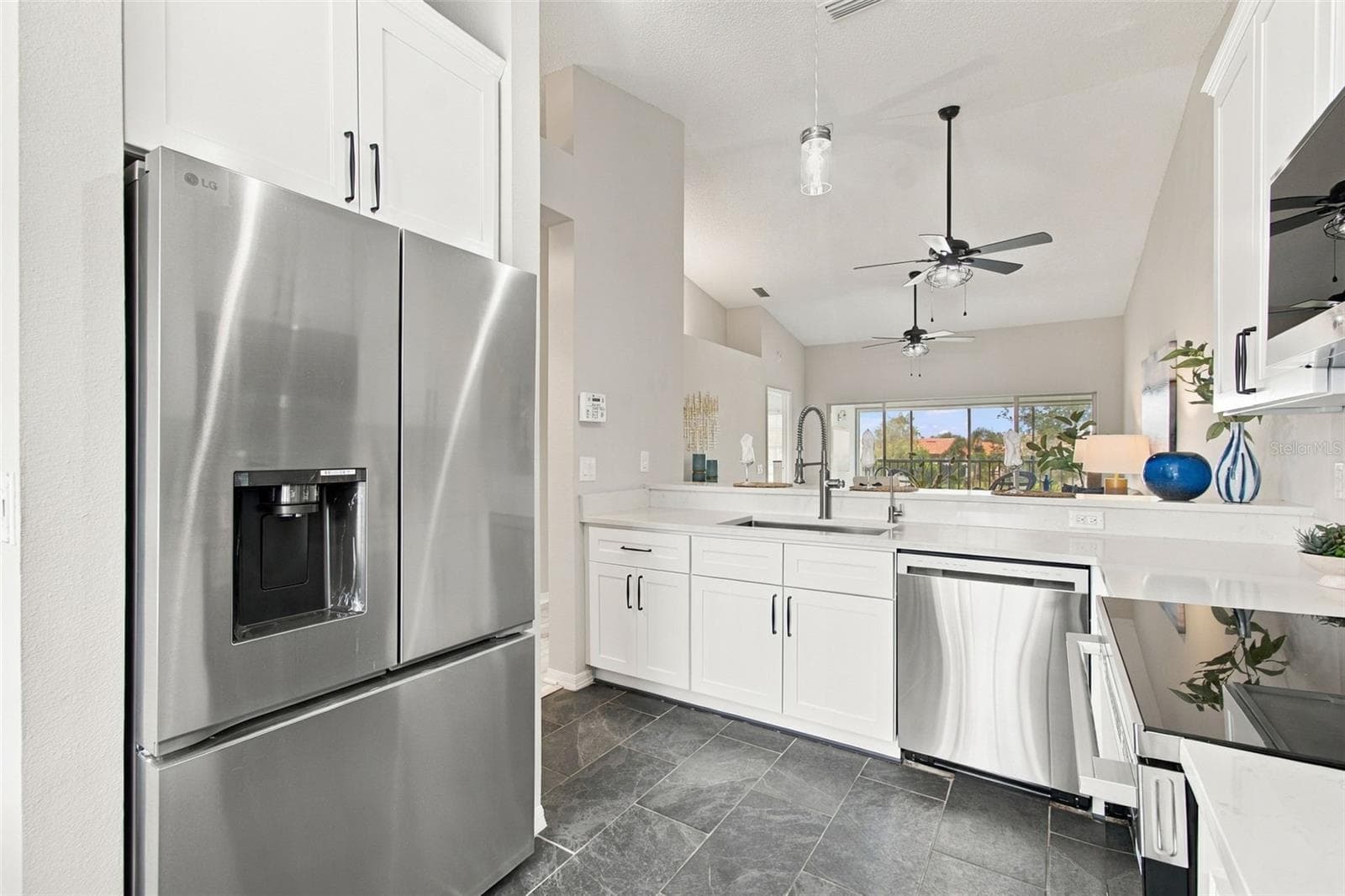 A LOOK FROM KITCHEN INTO LIVING AREA - 4210 CADDIE DR E #202, BRADENTON