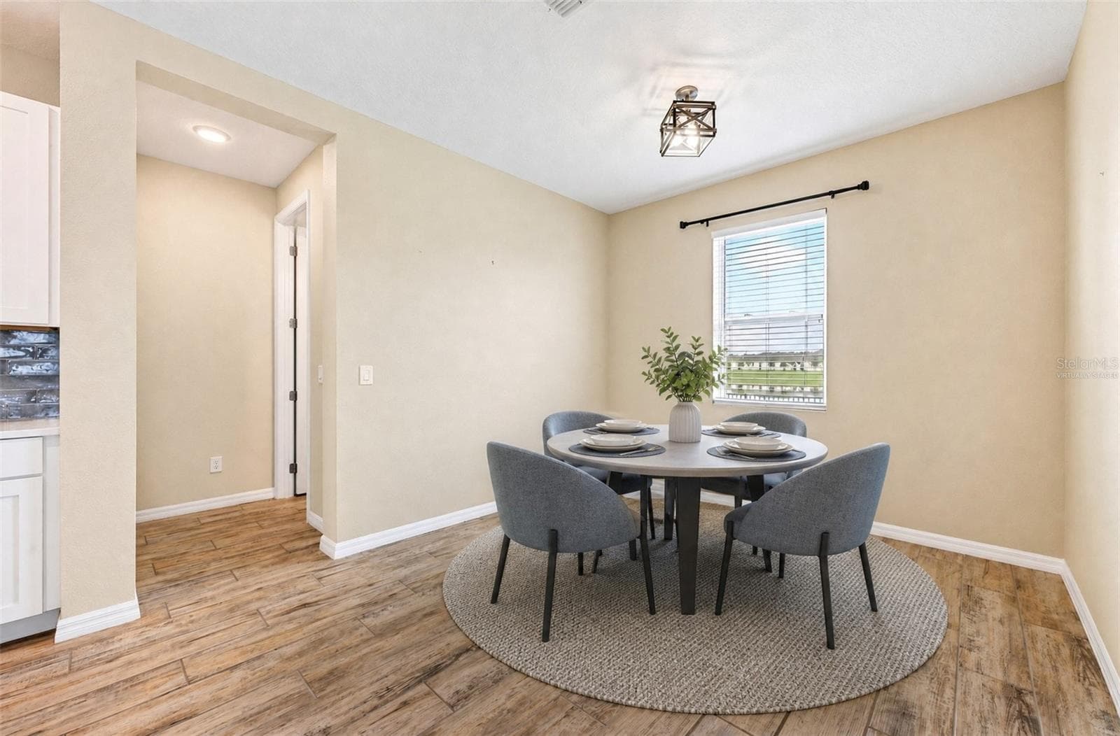 **Virtually Staged** Cozy breakfast nook with an updated light fixture - 880 LIVESTOCK LOOP, ST CLOUD