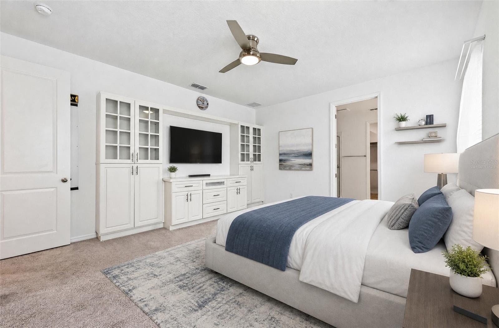 **Virtually Staged** Stunning primary suite with built-ins, carpet, and a ceiling fan - 880 LIVESTOCK LOOP, ST CLOUD