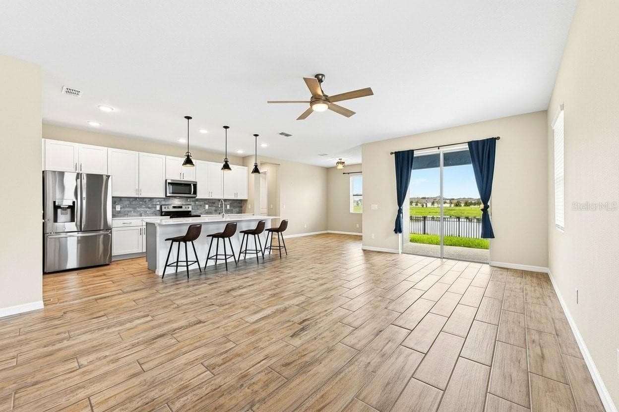 **Virtually Edited** Open-concept living space overlooked by the kitchen - 880 LIVESTOCK LOOP, ST CLOUD