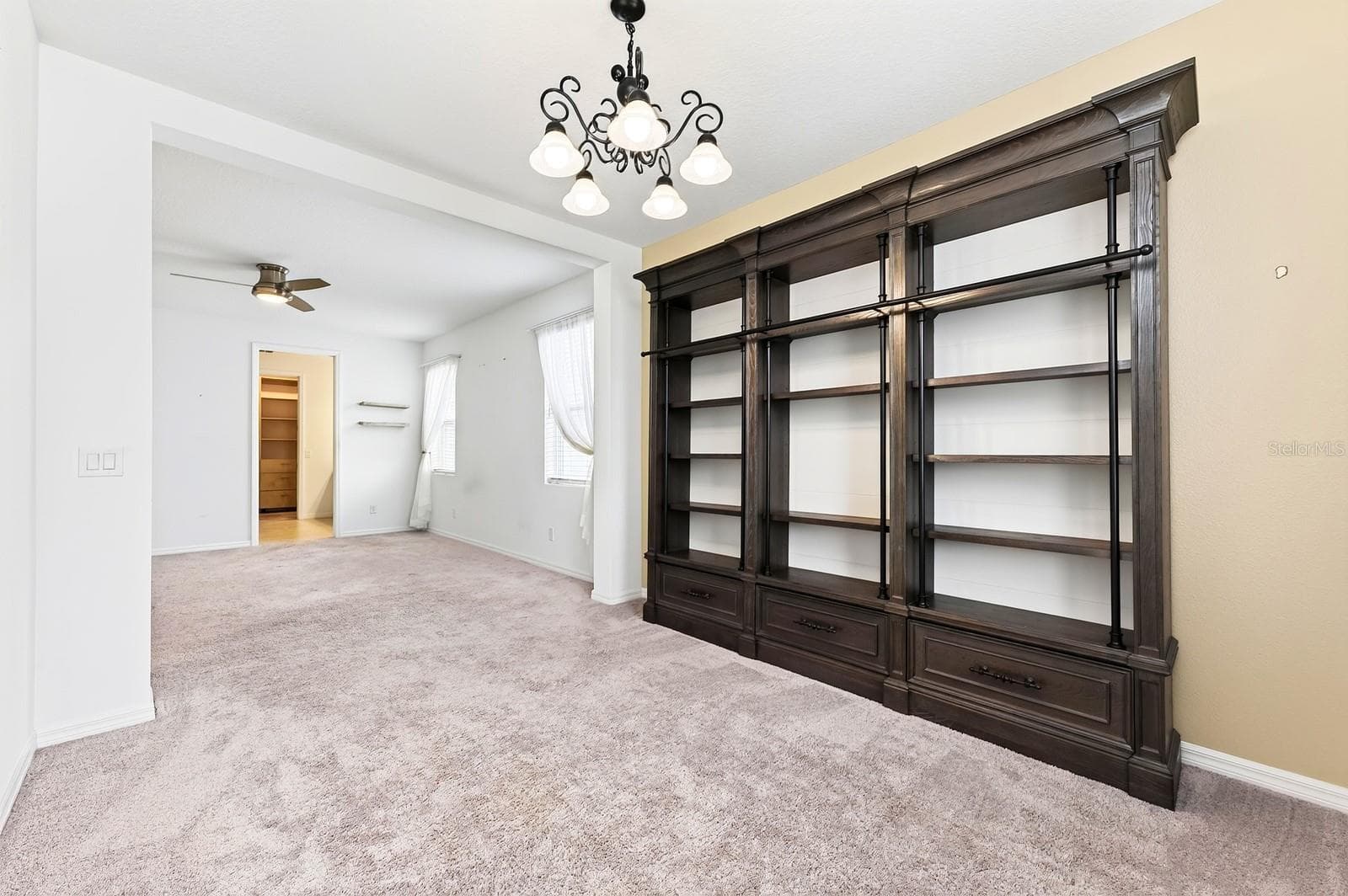 Amazing seating room area in the primary bedroom! You'll love the extra storage and display on the built-in shelves - 880 LIVESTOCK LOOP, ST CLOUD