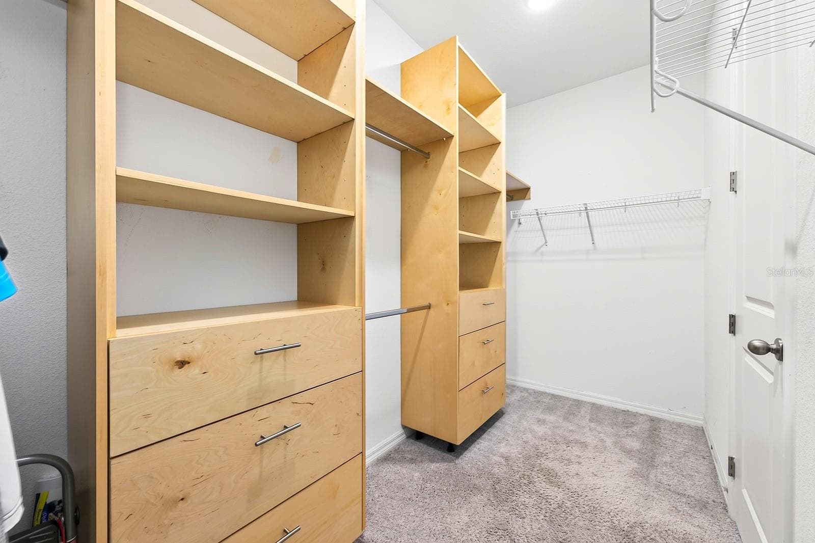 The primary bathroom has this large walk-in closet with BUILT-IN storage for all of your shopping excursions - 880 LIVESTOCK LOOP, ST CLOUD