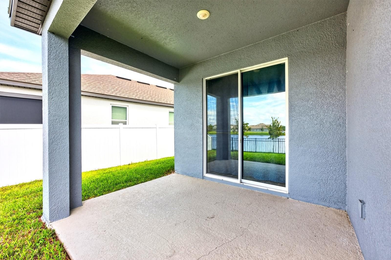 Great covered patio with a sliding door for extra natural light - 880 LIVESTOCK LOOP, ST CLOUD