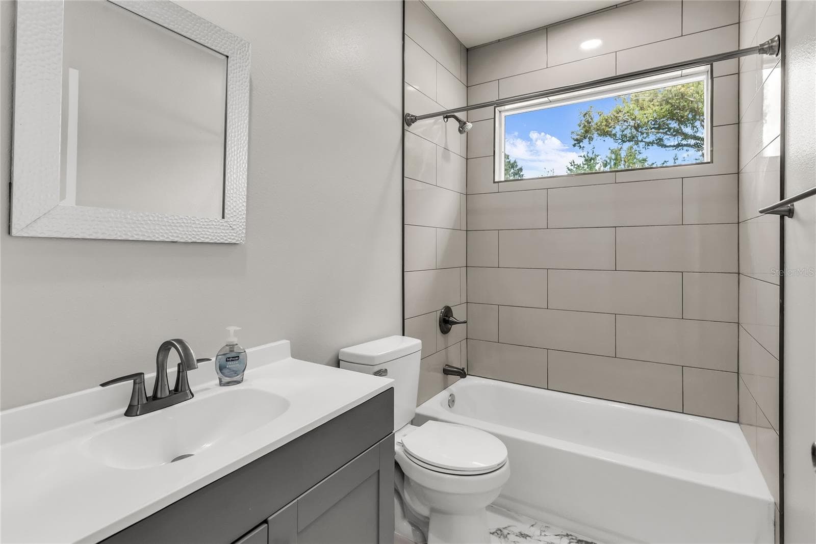 Hallway Bath features modern vanity, fixtures and tiled shower/tub combo - 3954 S SANFORD AVE, SANFORD