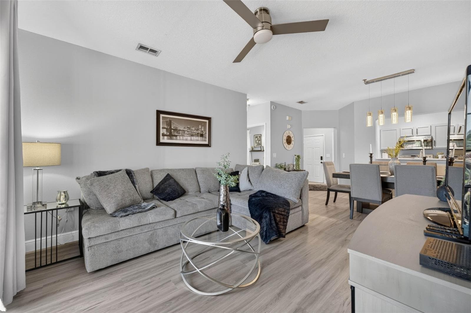 Living room looking toward dining area and kitchen - 4849 CYPRESS WOODS DR #1302, ORLANDO