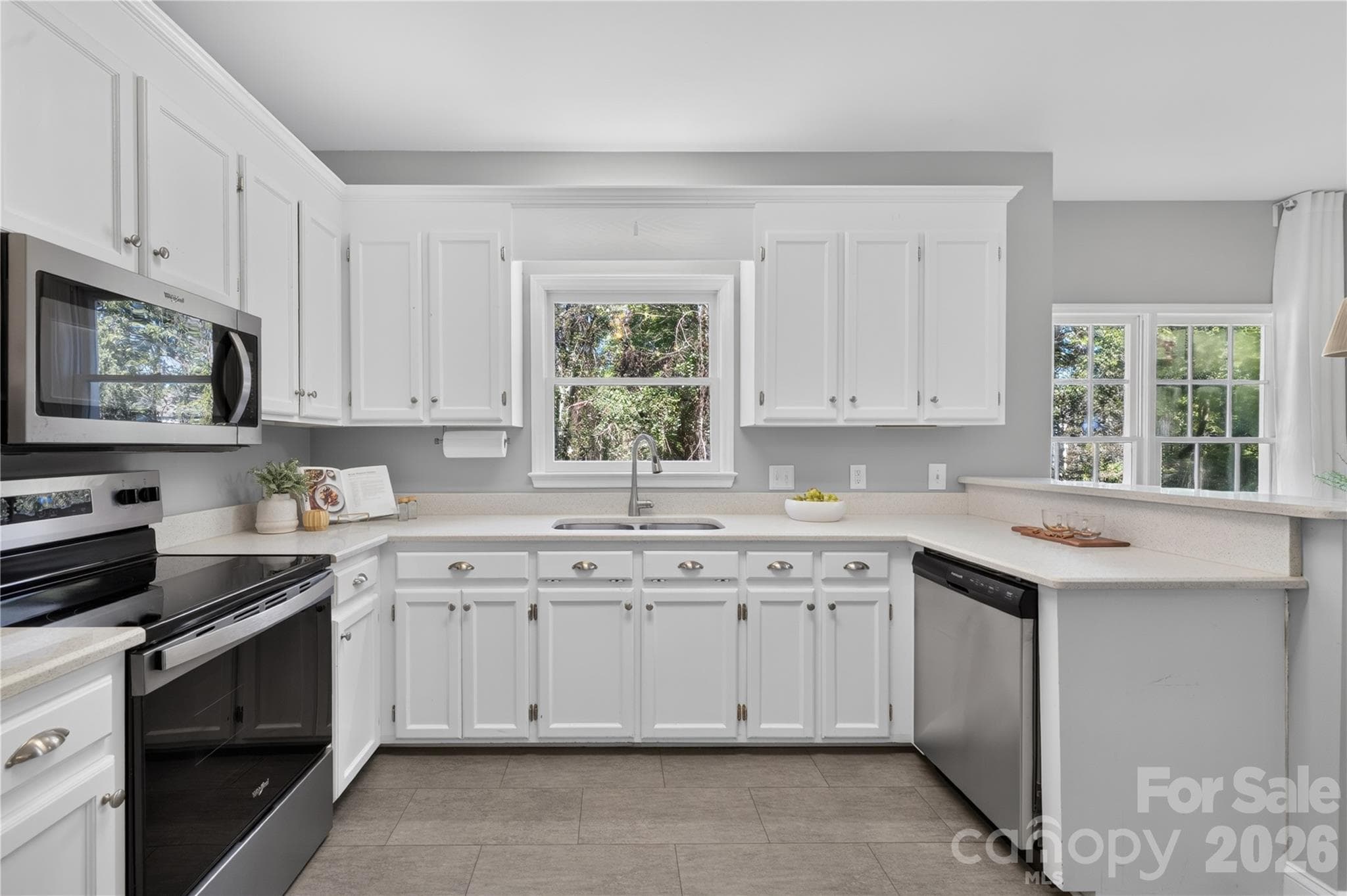 Kitchen with stainless steel appliances and quartz countertops. - 4711 Beech Crest Place, Charlotte