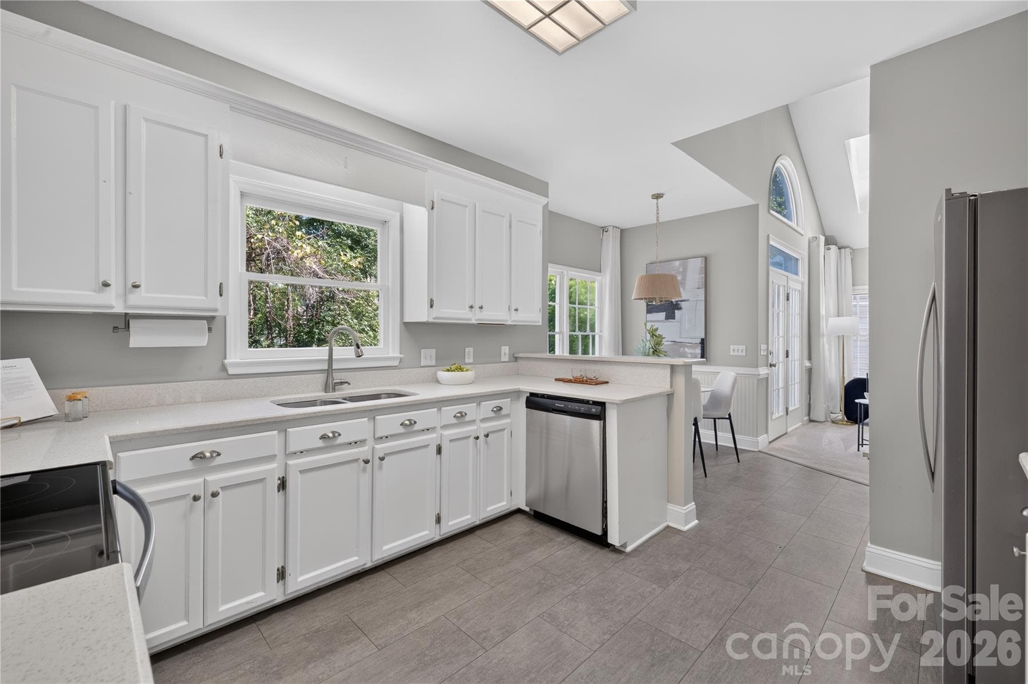 Kitchen with stainless steel appliances and quartz countertops. - 4711 Beech Crest Place, Charlotte