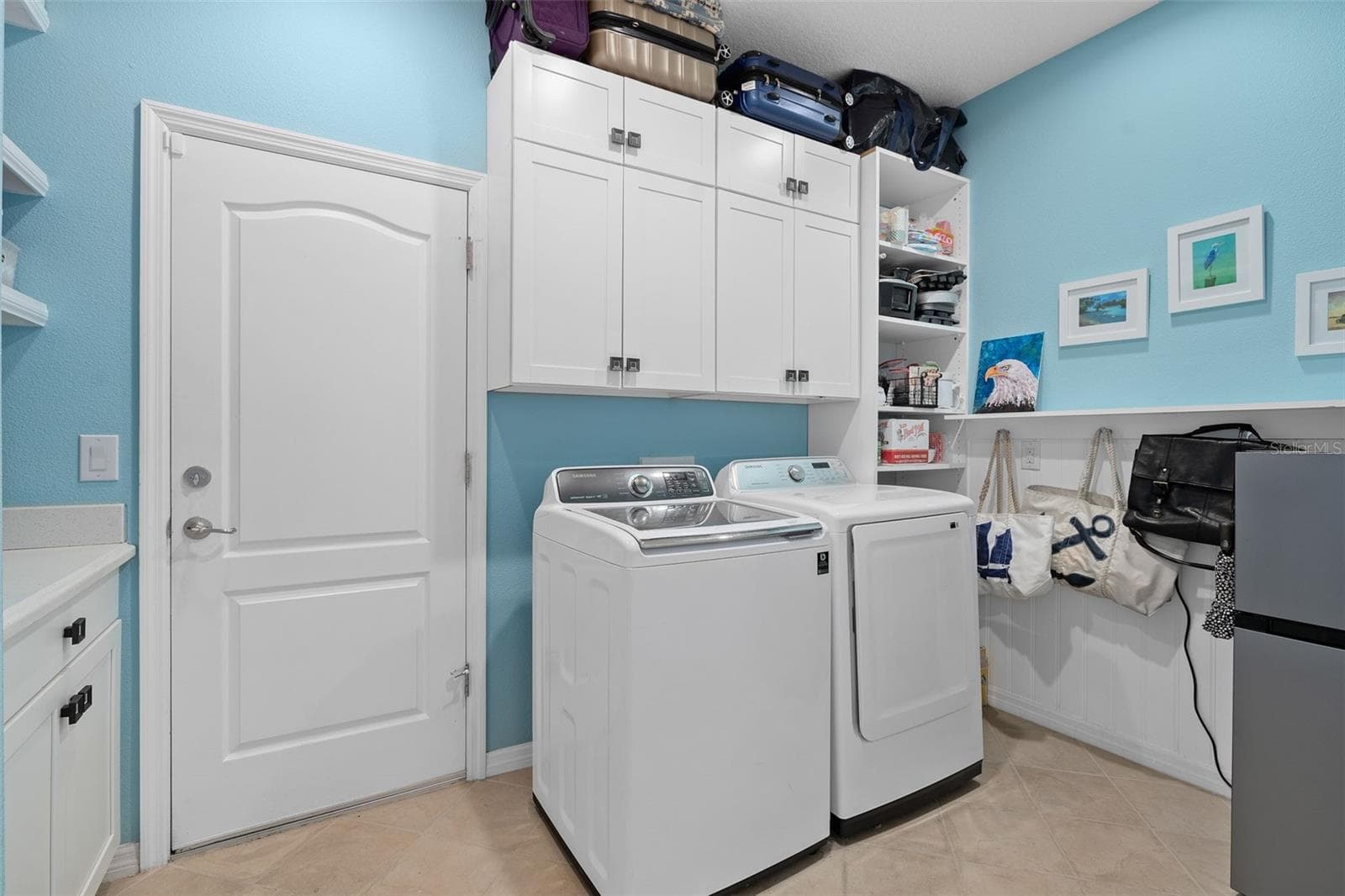 Laundry Room with a Drop Zone, Cabinetry and Custom Wall Treatment - 1038 TIMBERVALE TRL, CLERMONT