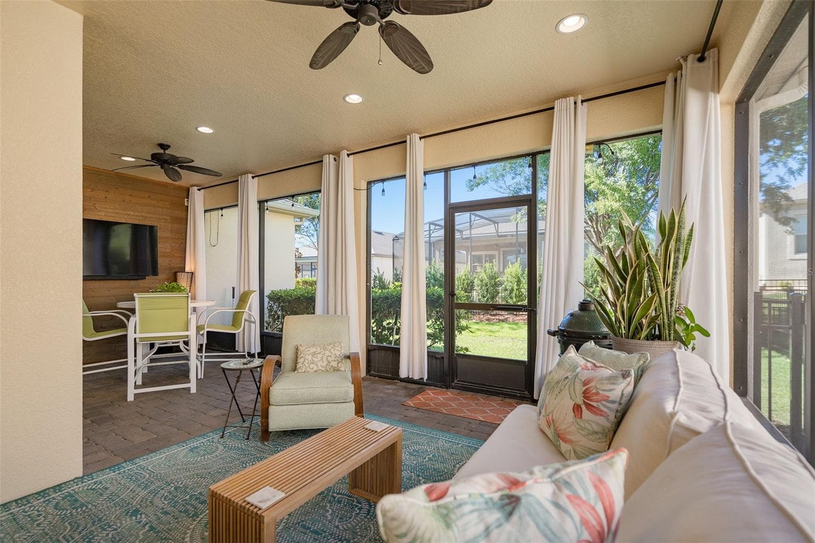 Enjoy the Screened Lanai with a Wood Accent Wall with TV connections, 2 Ceiling Fans and Pavers - 1038 TIMBERVALE TRL, CLERMONT