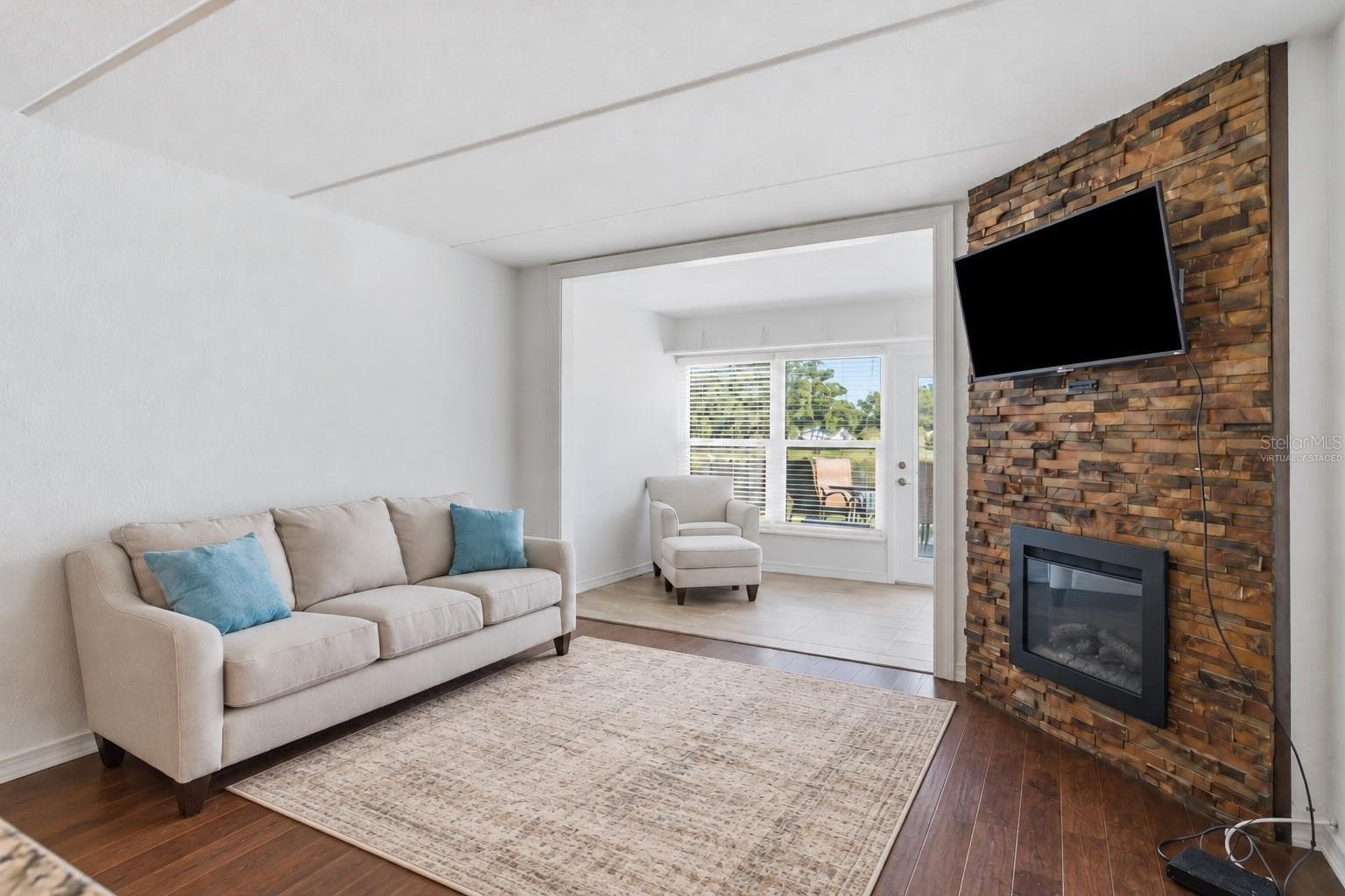 Cozy family room -Virtually staged rug - 821 DELEON CT #109, DUNEDIN