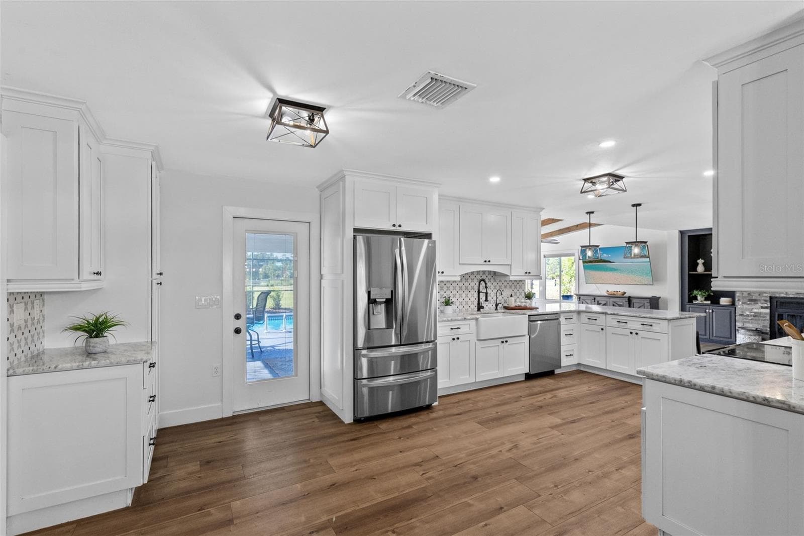 Beautifully renovated Kitchen with French door leading to poo lanai. - 2670 MILLS CREEK RD, CHULUOTA