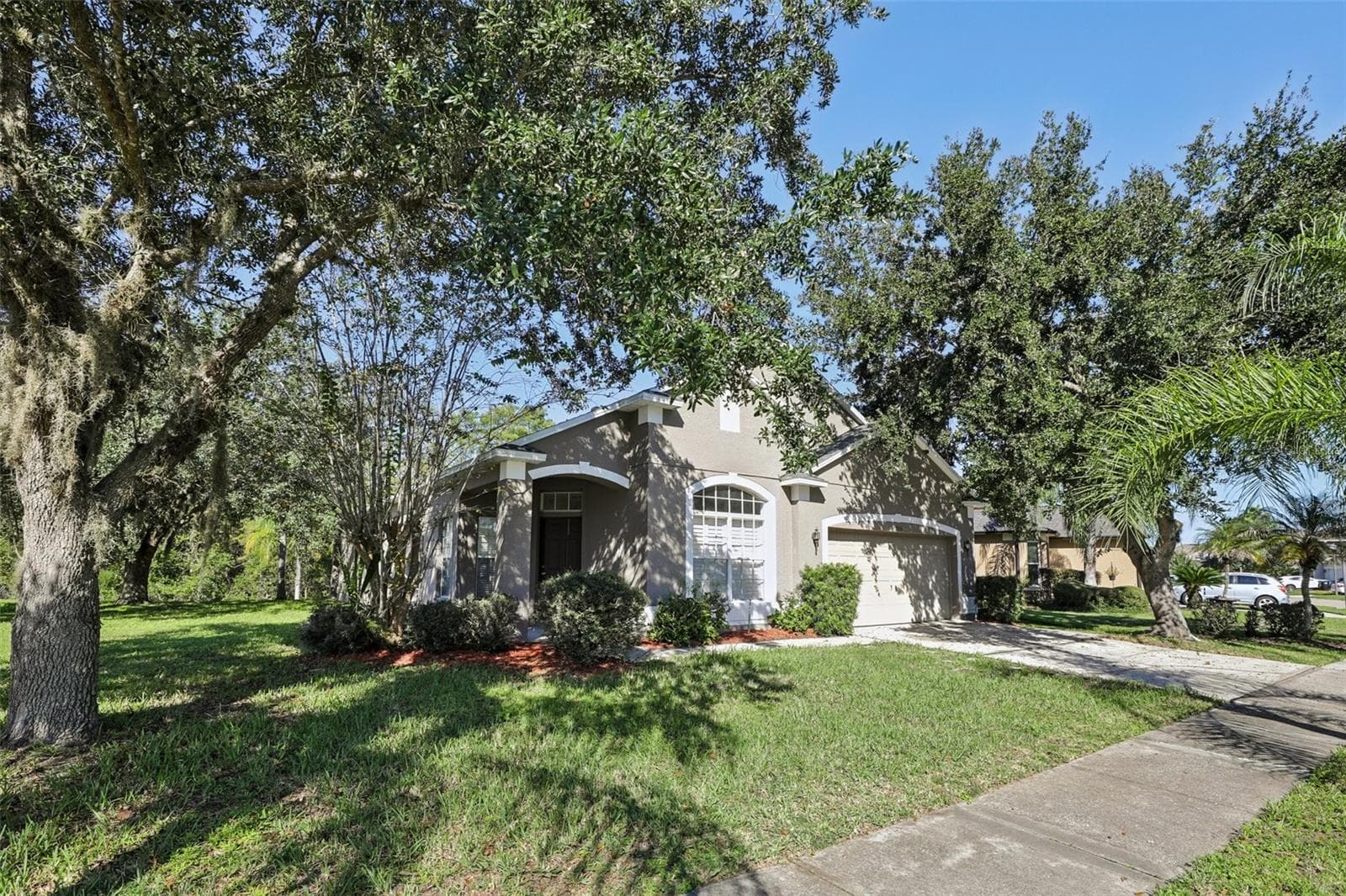 Situated on an OVERSIZED, CORNER LOT with no rear neighbors, the property features GREAT CURB APPEAL mature landscaping and large shade trees that create a welcoming setting. - 1806 ANNA CATHERINE DR, ORLANDO