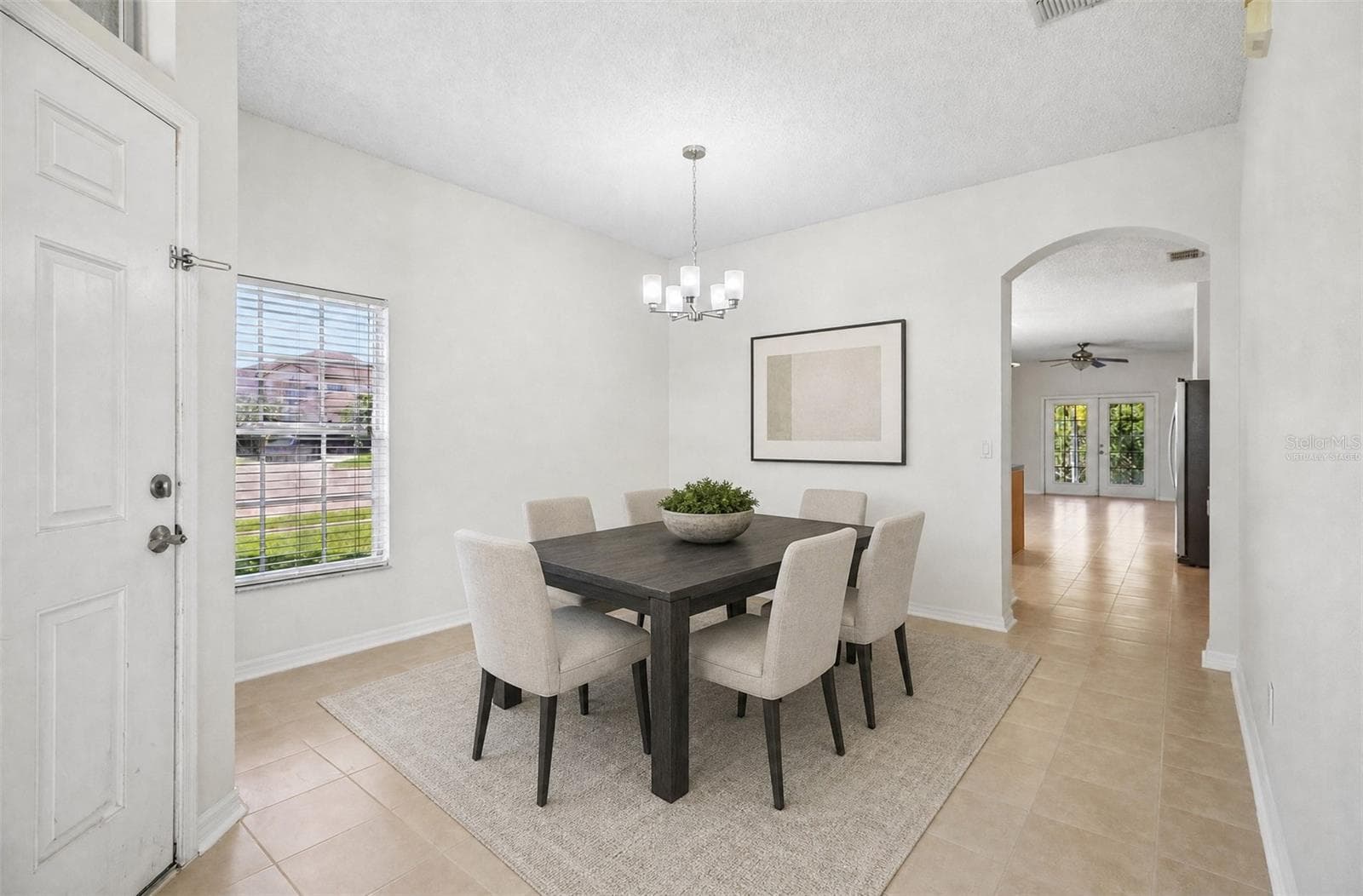 The separate formal Dining Room sits on the opposite side of the foyer, overlooking the front yard. Virtually Staged - 1806 ANNA CATHERINE DR, ORLANDO