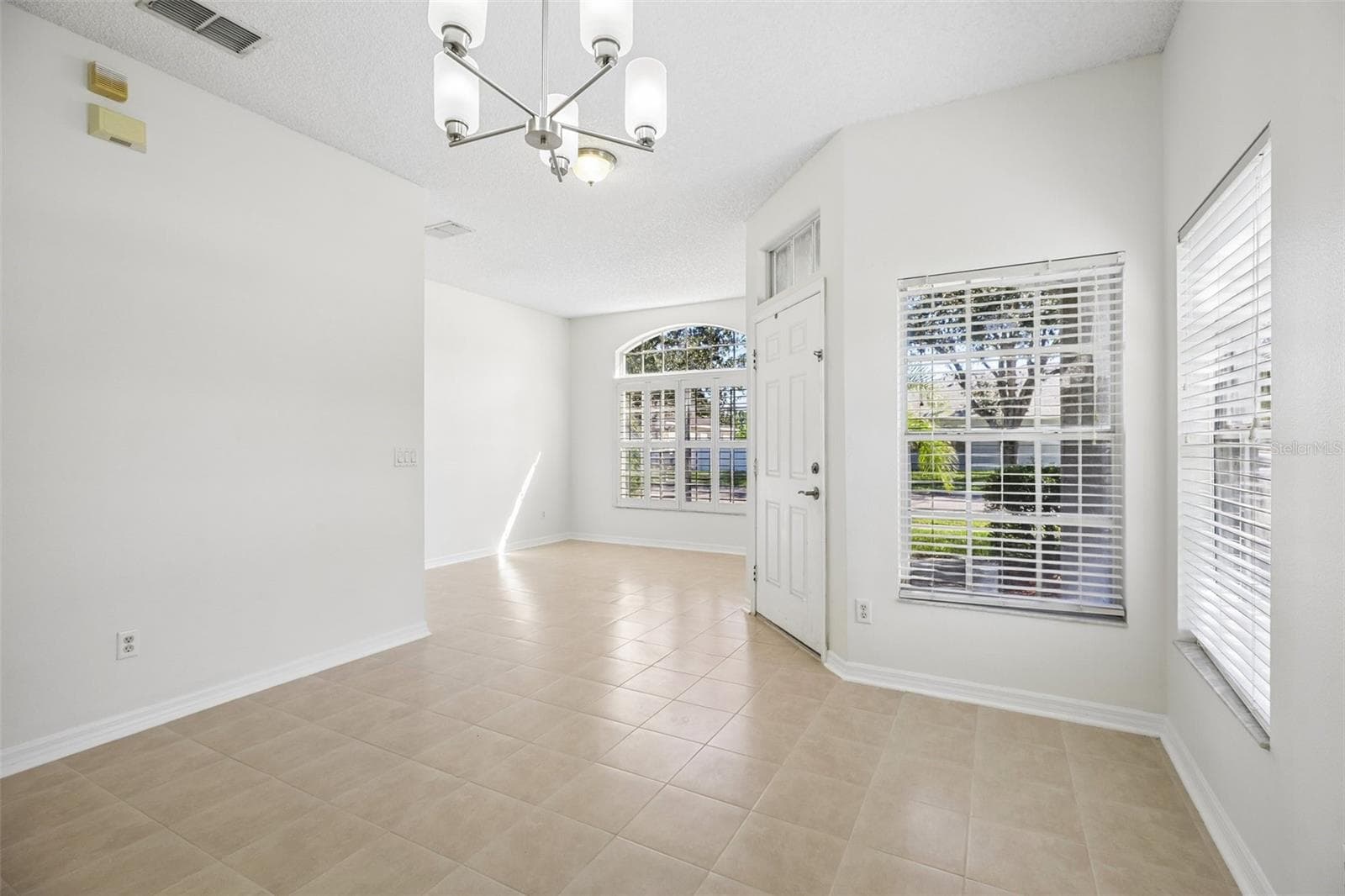 The separate formal Dining Room sits on the opposite side of the foyer, overlooking the front yard. - 1806 ANNA CATHERINE DR, ORLANDO