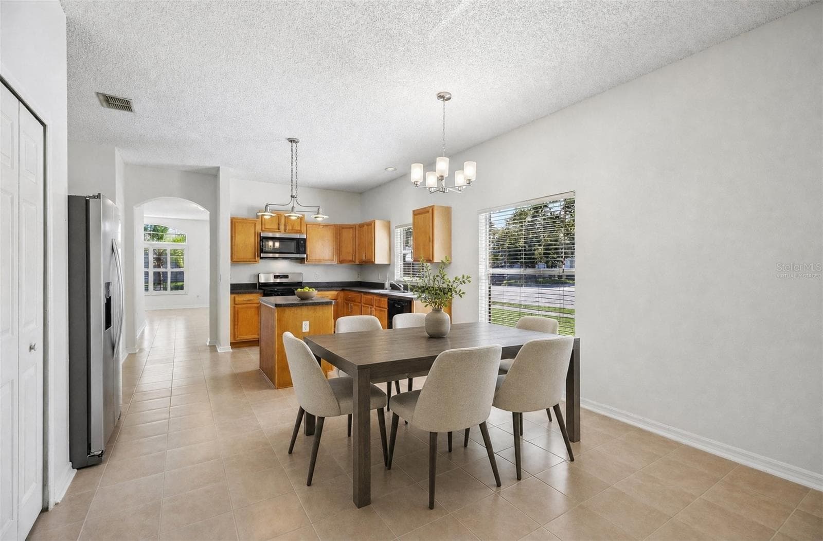 A Breakfast Nook in front of a LARGE PICTURE WINDOW, presents a bright spot for morning coffee or casual meals. Virtually Staged - 1806 ANNA CATHERINE DR, ORLANDO