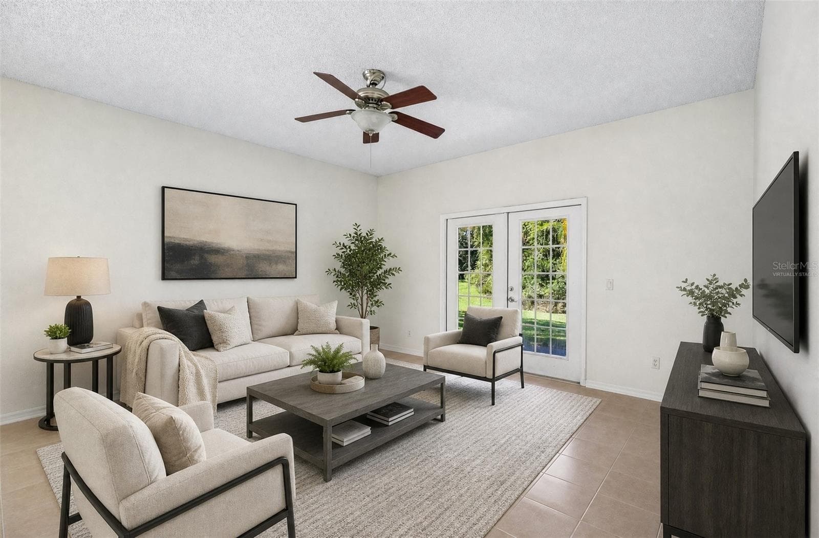 GLASS-PANELED FRENCH DOORS in the Family Room open to the covered back patio, making indoor-outdoor living and entertaining easy. Virtually Staged - 1806 ANNA CATHERINE DR, ORLANDO