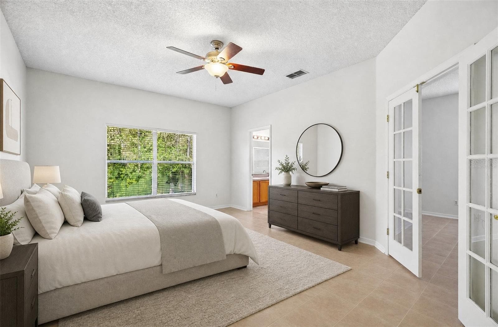 The GENEROUS PRIMARY SUITE provides a relaxing retreat complete with a remarkably SPACIOUS WALK-IN CLOSET and an en suite Bath. Virtually Staged - 1806 ANNA CATHERINE DR, ORLANDO