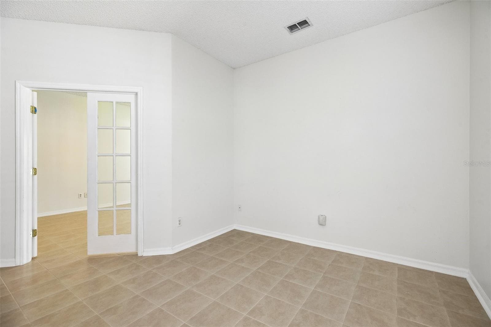 Glass-paneled French doors lead from the Primary Suite to a BONUS ROOM that could serve as a home office, nursery, hobby room, or POTENTIAL FOURTH BEDROOM, depending on your needs. - 1806 ANNA CATHERINE DR, ORLANDO