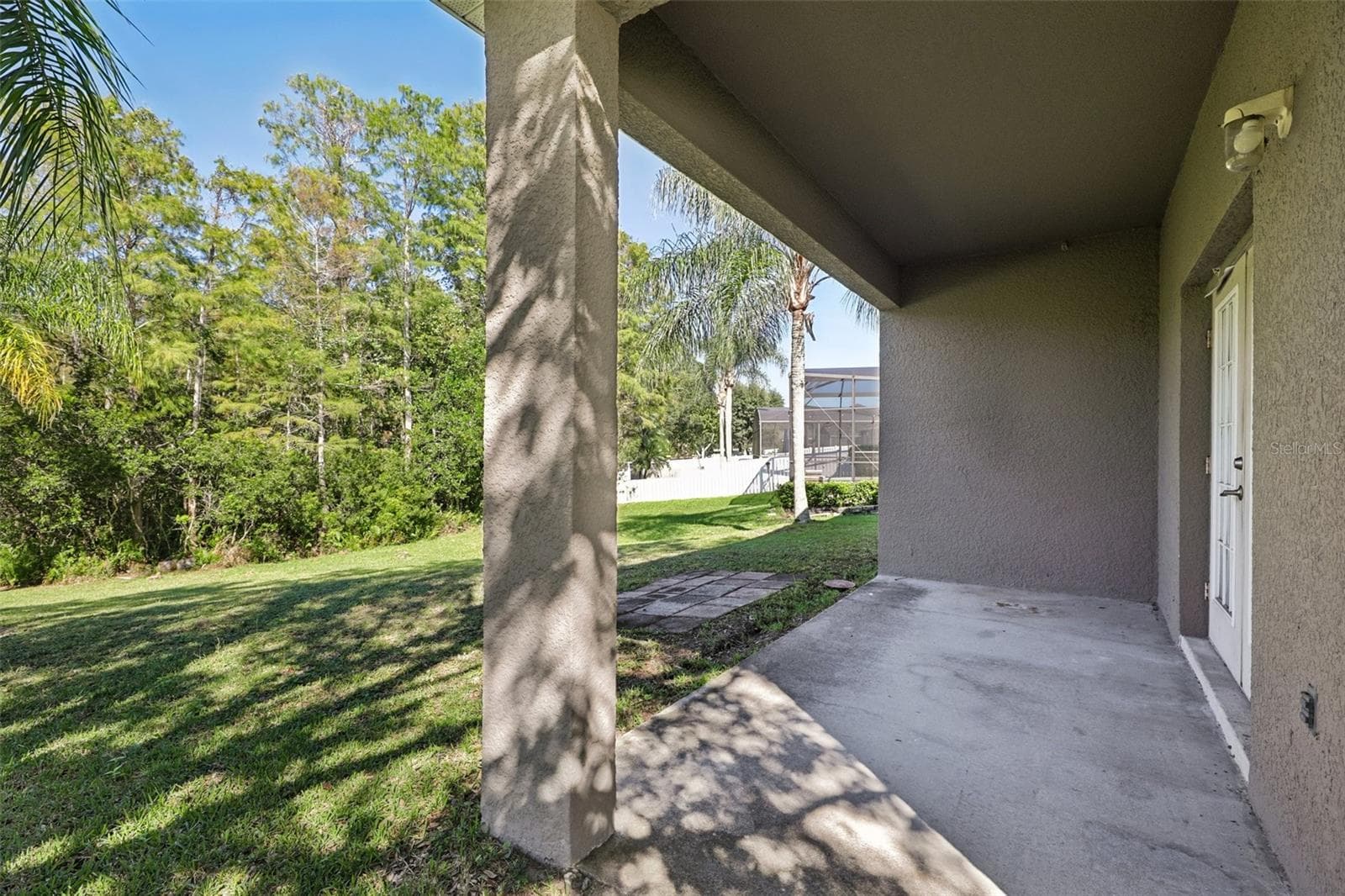 The covered backyard patio and EXPANSIVE OUTDOOR SPACE provide plenty of room to relax and enjoy the Florida lifestyle. - 1806 ANNA CATHERINE DR, ORLANDO