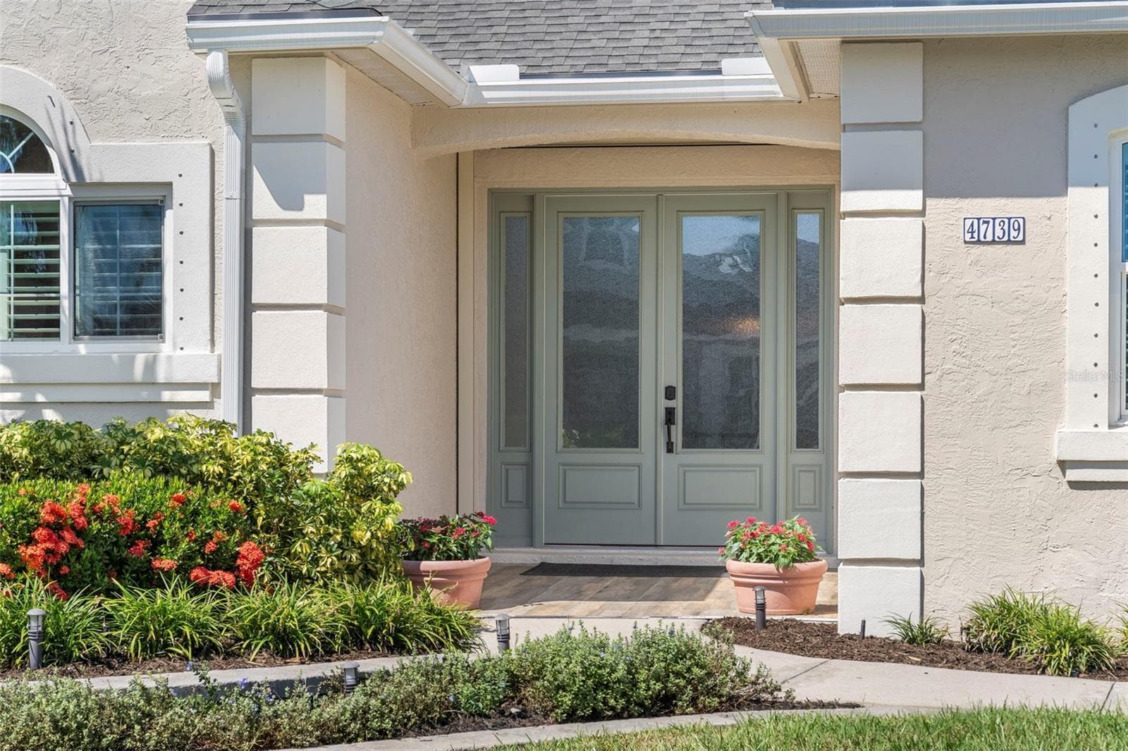 Thoughtful landscaping and a welcoming covered entry introduce this move-in-ready home, professionally renovated inside and out in 2021. - 4739 COMPASS DR, BRADENTON