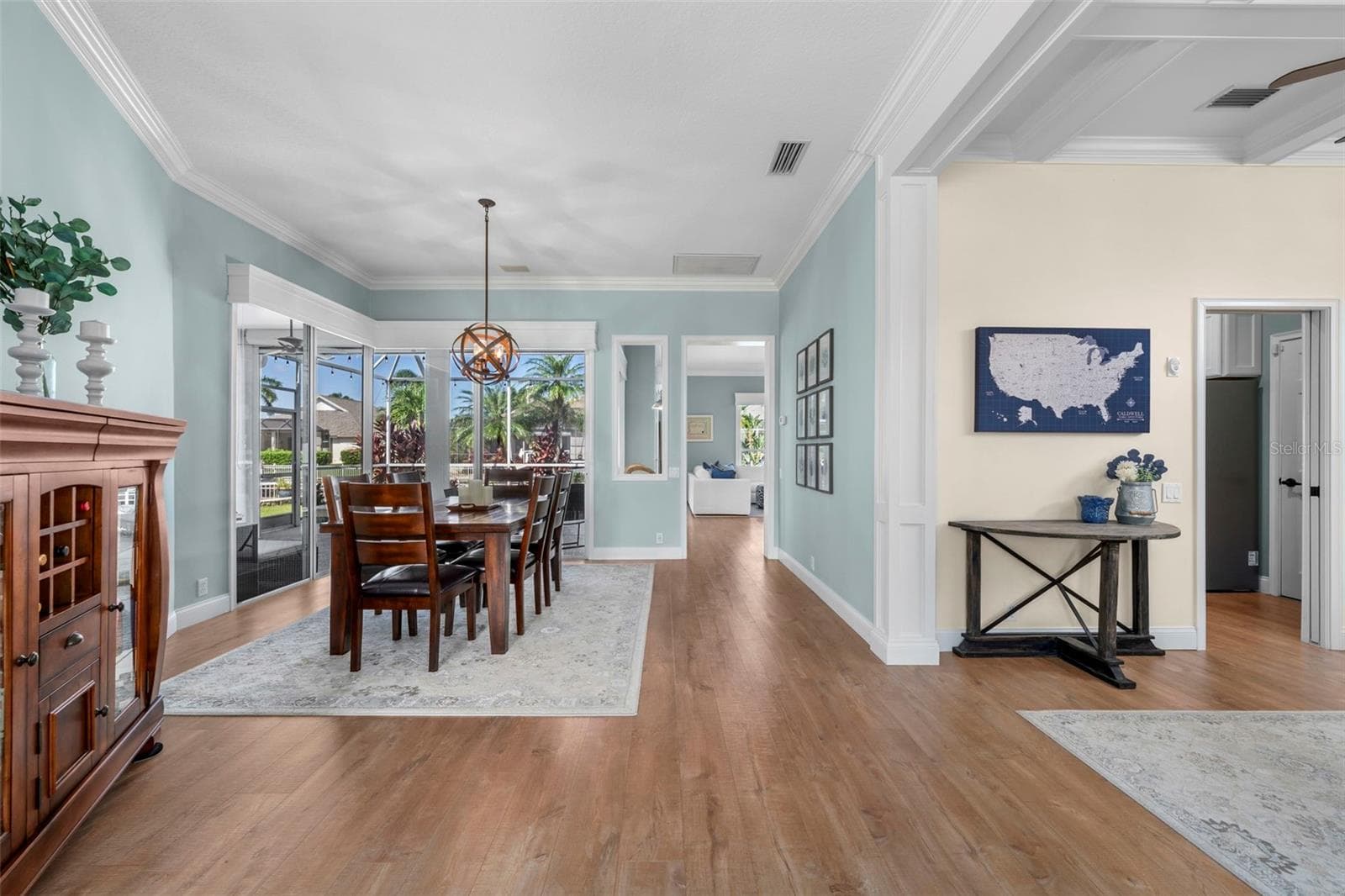 An open, inviting layout connects the dining area and den, with thoughtful architectural details throughout. - 4739 COMPASS DR, BRADENTON