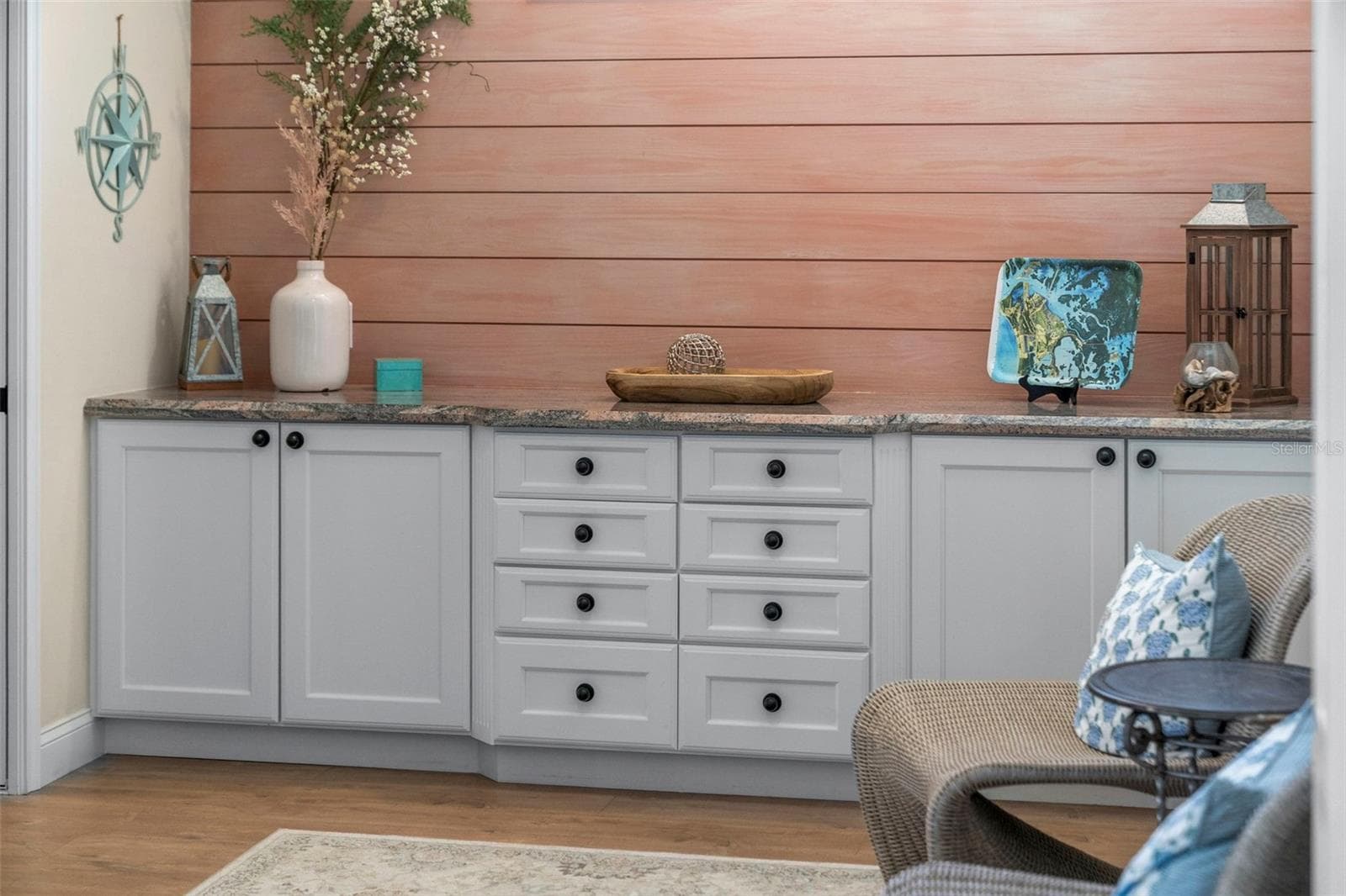 A shiplap accent wall and generous built-in cabinetry bring warmth and practical storage to this comfortable retreat. - 4739 COMPASS DR, BRADENTON
