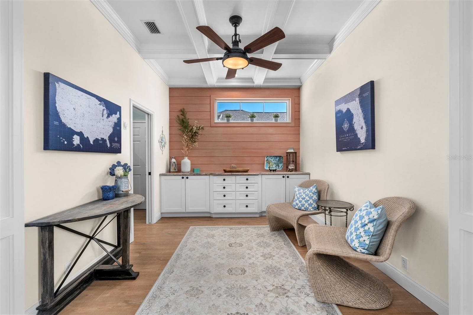 Beautiful ceiling details and wide openings keep the den connected to the home’s gathering spaces. - 4739 COMPASS DR, BRADENTON