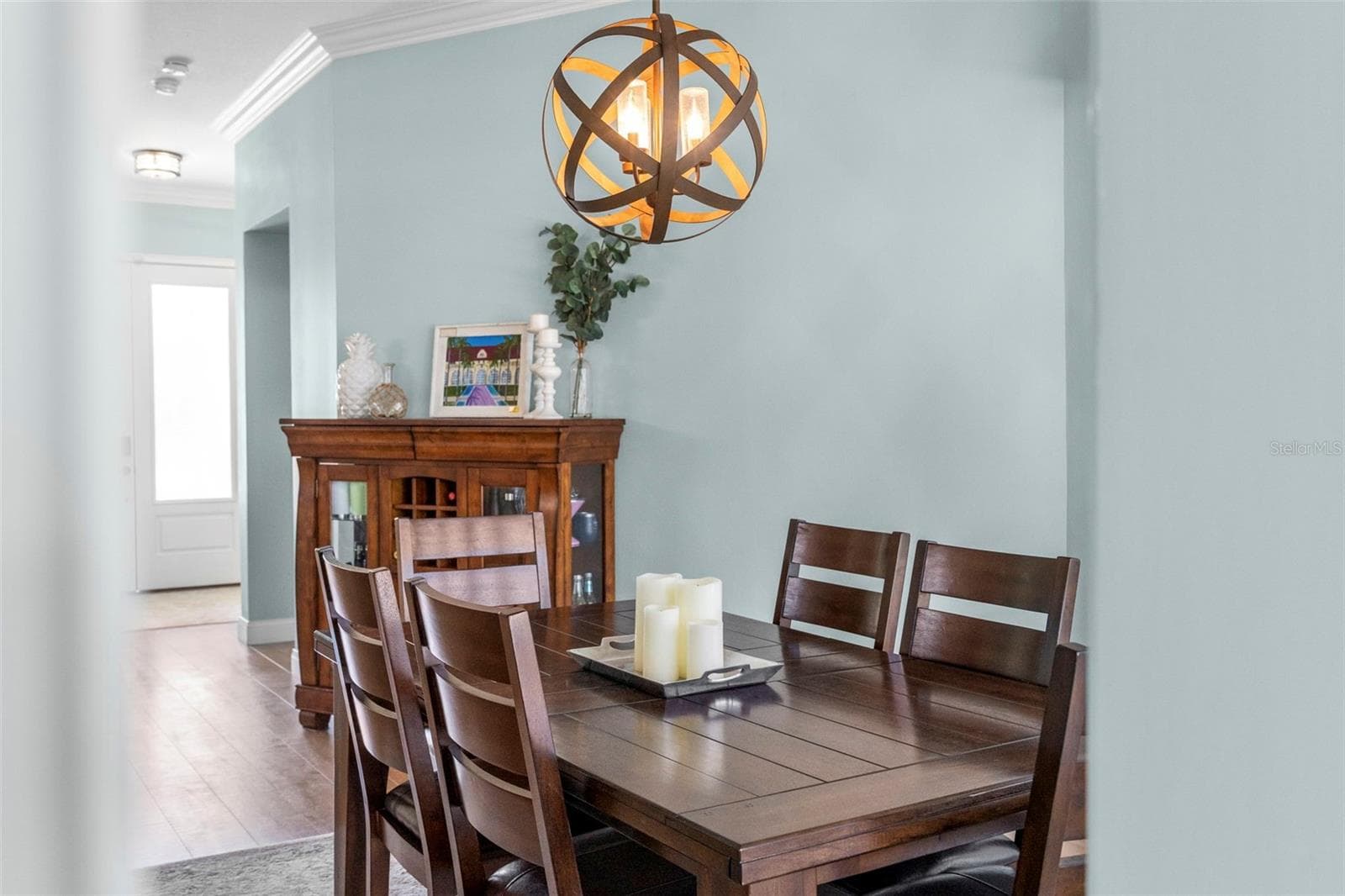 Soft coastal tones and a sculptural light fixture make this an inviting place to gather around the table. - 4739 COMPASS DR, BRADENTON