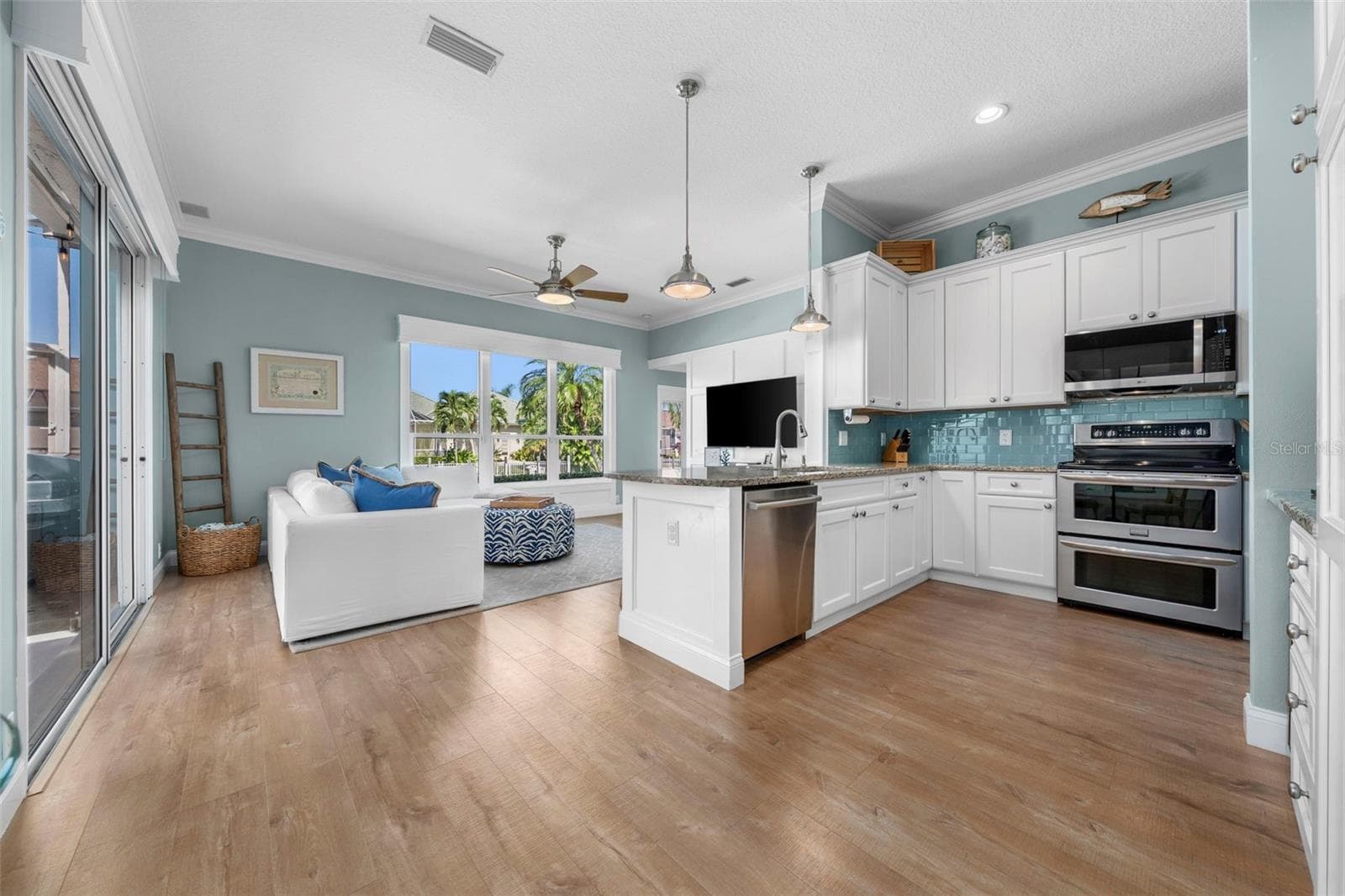 Granite countertops, custom maple cabinetry, and an open connection to the living area make everyday cooking and gathering with friends feel easy. - 4739 COMPASS DR, BRADENTON