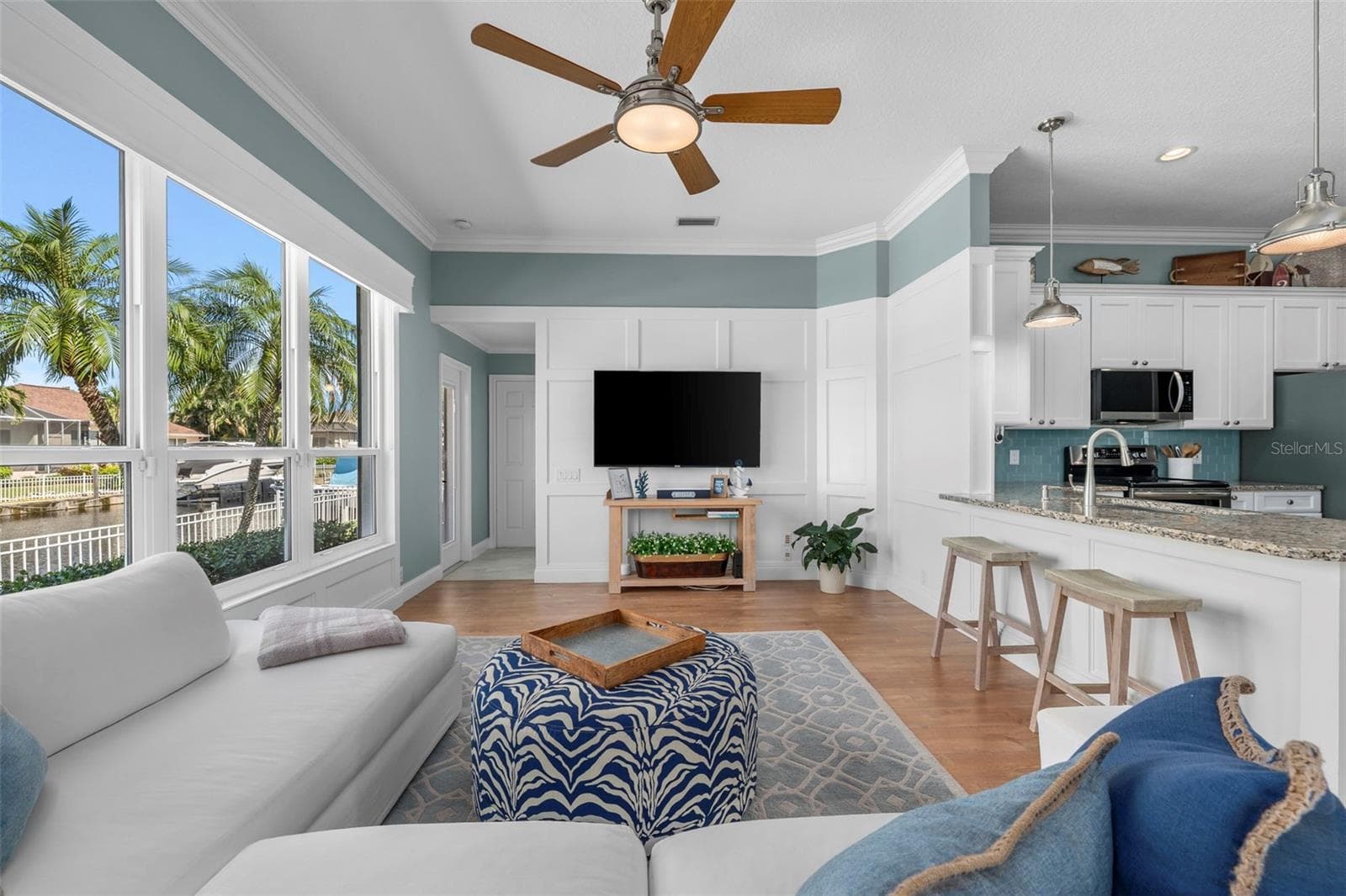 Enjoy canal views from the living area, with breakfast-bar seating keeping everyone connected to the kitchen. - 4739 COMPASS DR, BRADENTON