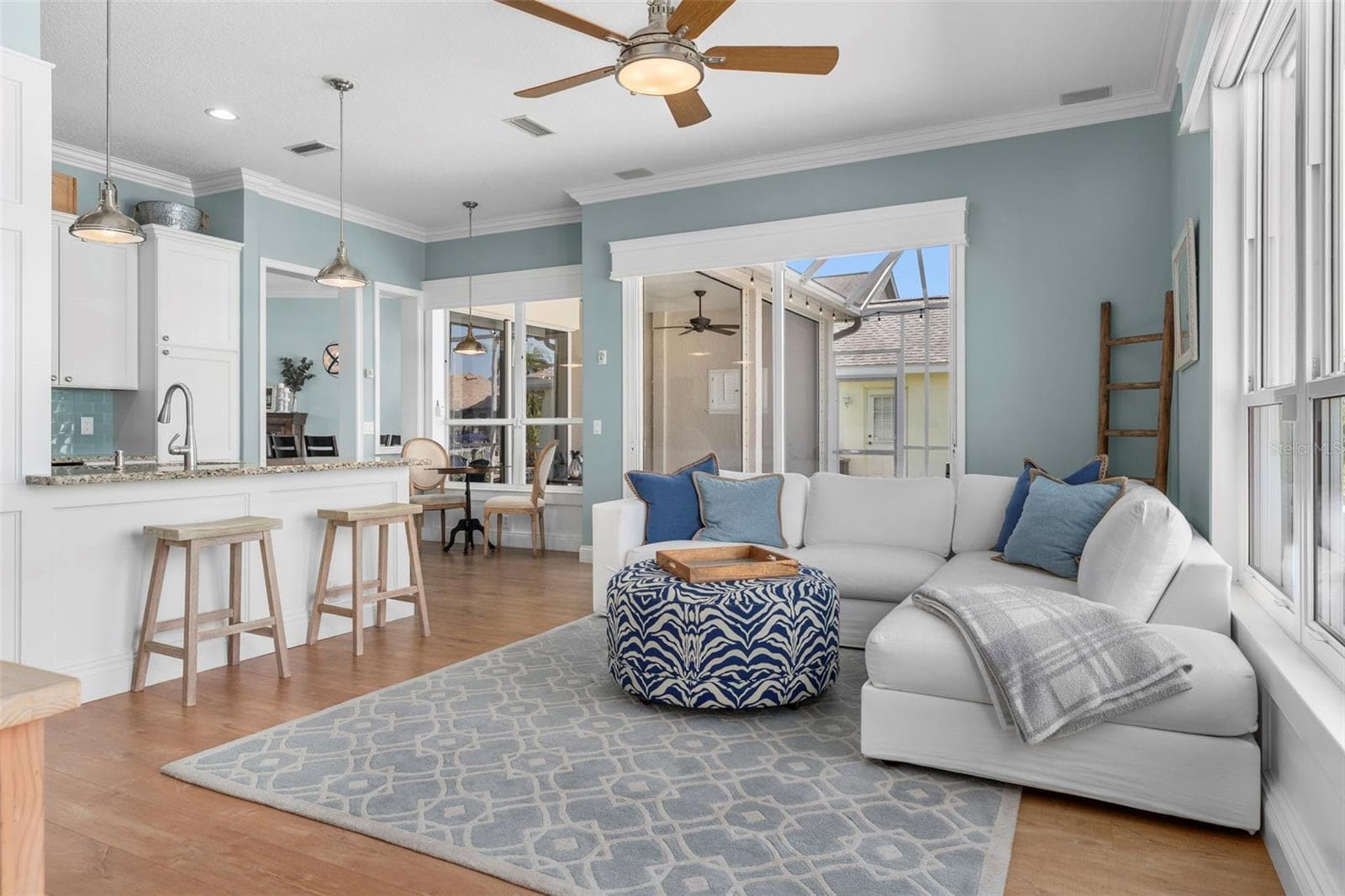 Sliding glass doors open to the covered lanai, extending this comfortable gathering space outdoors - 4739 COMPASS DR, BRADENTON