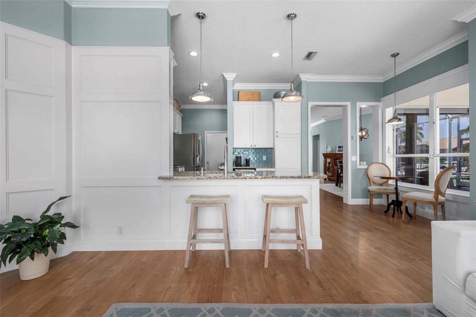 A granite breakfast bar offers a casual place to sit, chat, and keep the cook company. - 4739 COMPASS DR, BRADENTON
